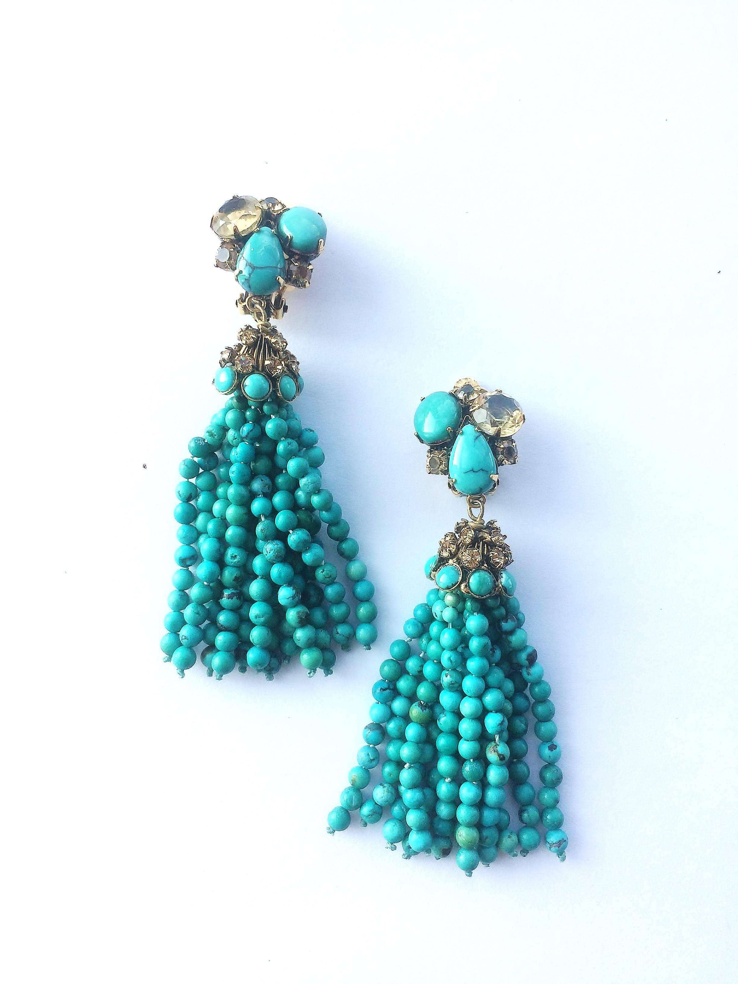 A subtle and magical colour combination of strong turquoise and soft citrine, highlighted with bohemian bronze pastes, set in gilt metal, set these earrings apart. Handmade by the studio of Iradj Moini, they form  'tassles' of turquoises, with