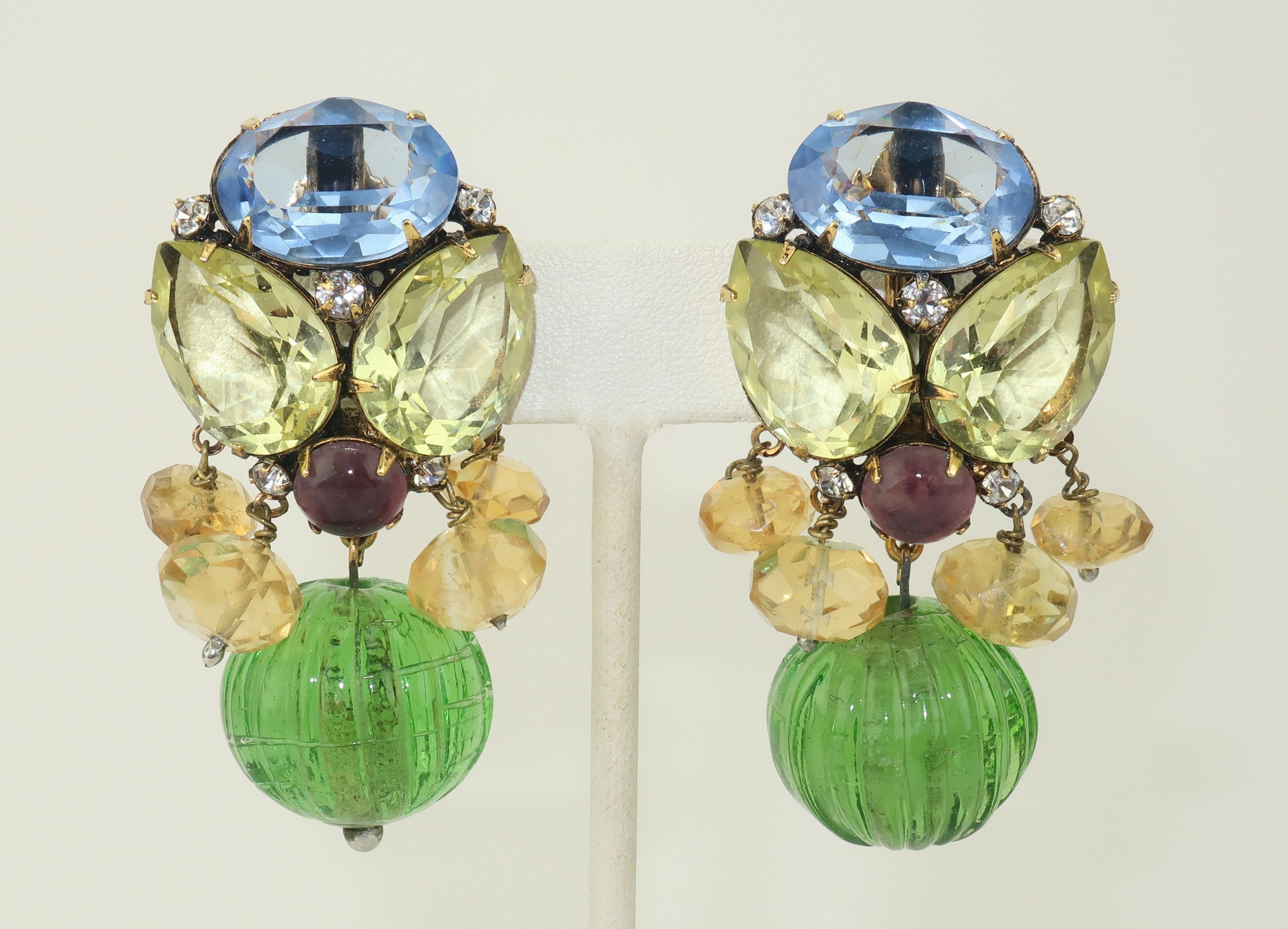 Gorgeous Iradj Moini clip on earrings designed with yellow quartz, citrine and amethyst semi precious stones accented by blue crystal and a green glass orb dangle.  The gilt gold setting is backed with clip on hardware and hallmarked with medallions