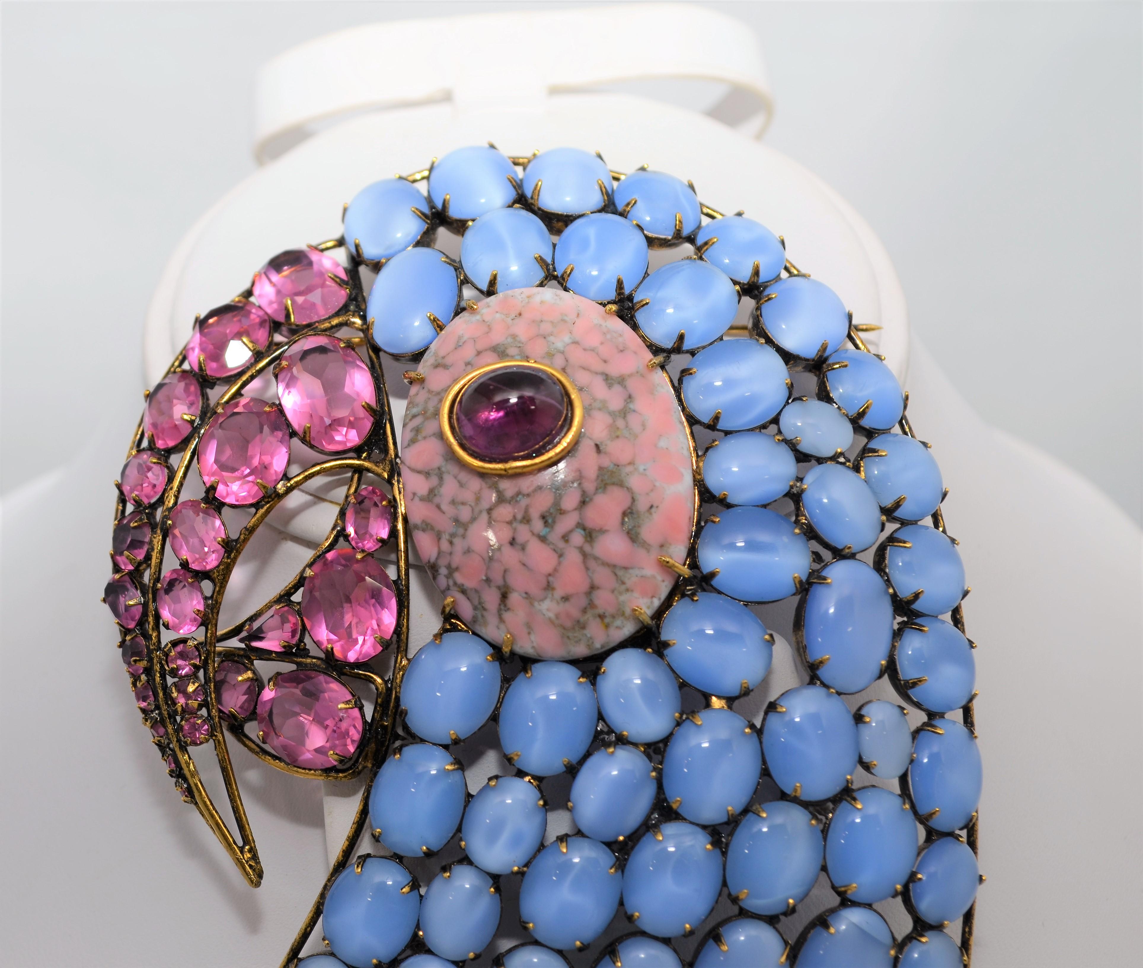 Iradj Moini brooch delicately handmade featuring multi-colored stones on a 18k gold-plated brass and is signed at the back. Each gem was handset and chosen from the finest provenance.

Brooch measurements: 4'' x 5'' In pristine condition with no
