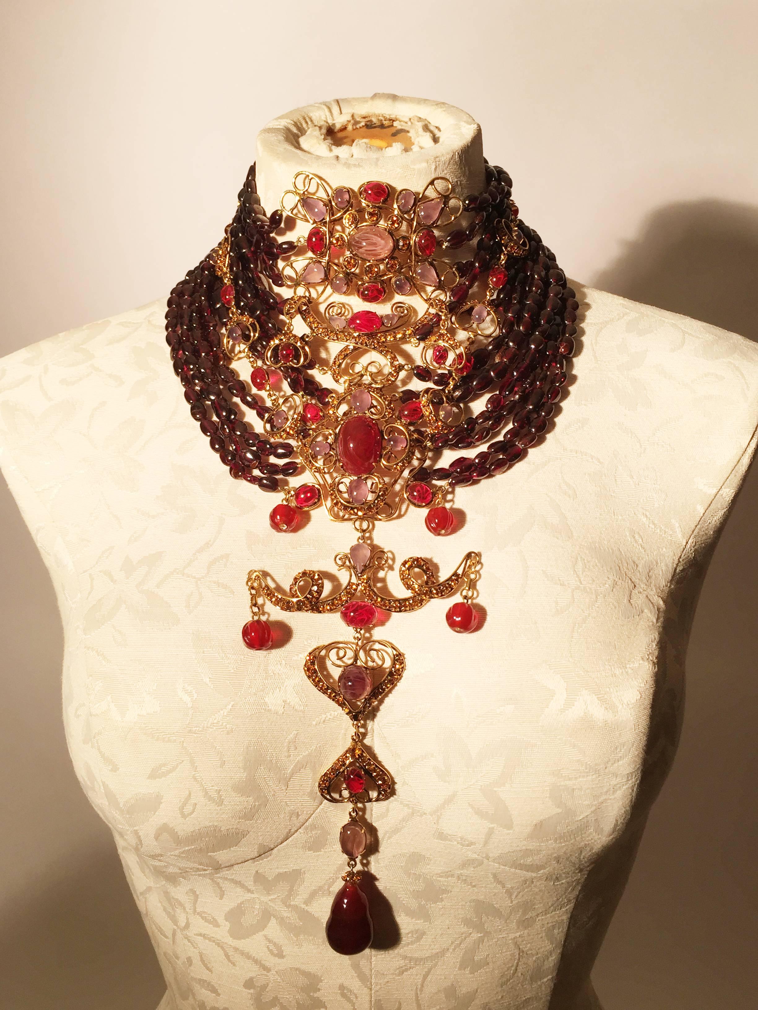 Iradj Moini statement necklace, this super glamorous necklace is not for the shy diva! Comprised of centre flawed glass cabochon medallions accented by Amber Swarorski crystals and suspended from 12 rows of garnets. Dangling Gripoix glass tear