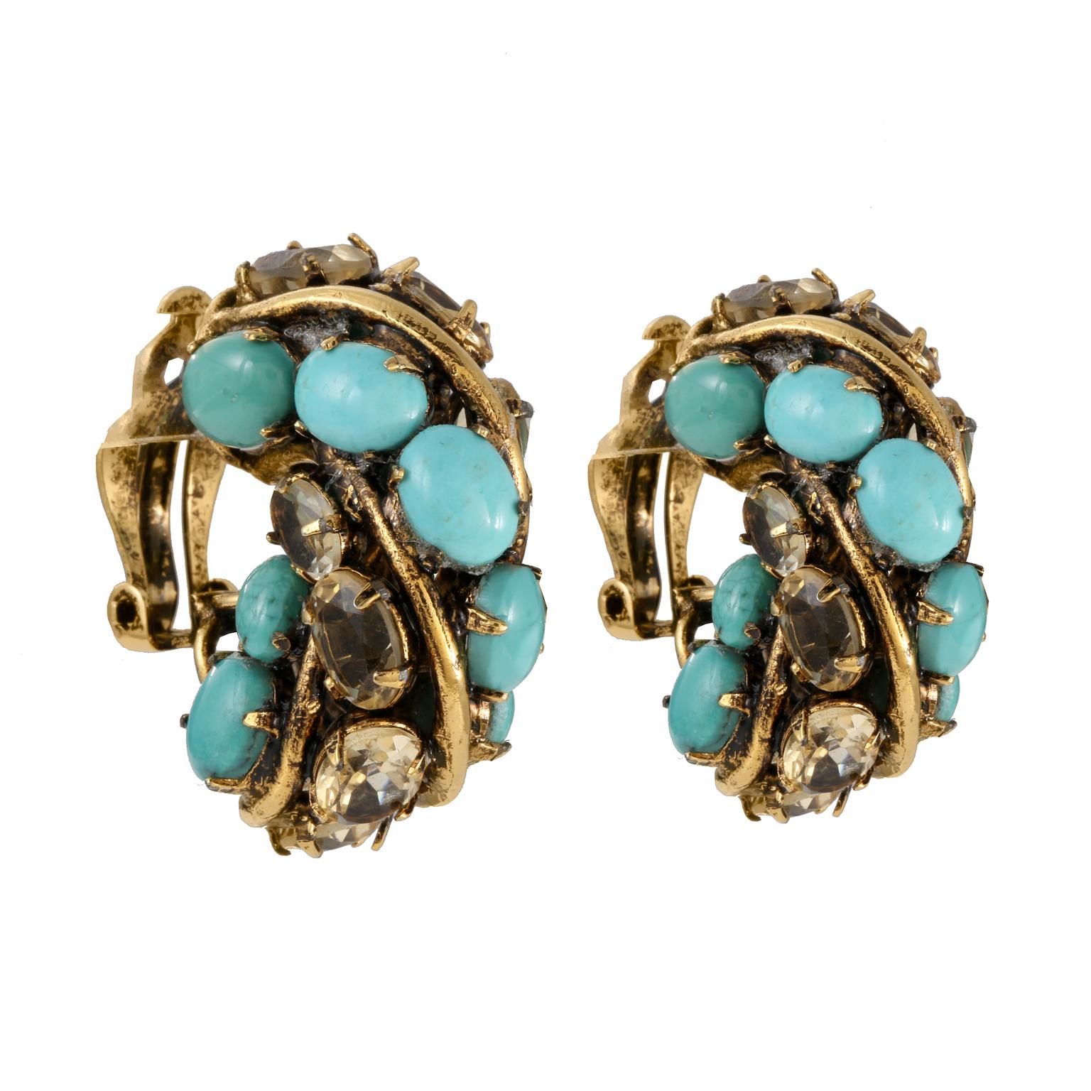 These Iradj Moini Turquoise and Crystal Earrings are in excellent condition.  Turquoise and crystal stones set in in gold tone metal.  Clip on closure.  Pouch or box included. 

