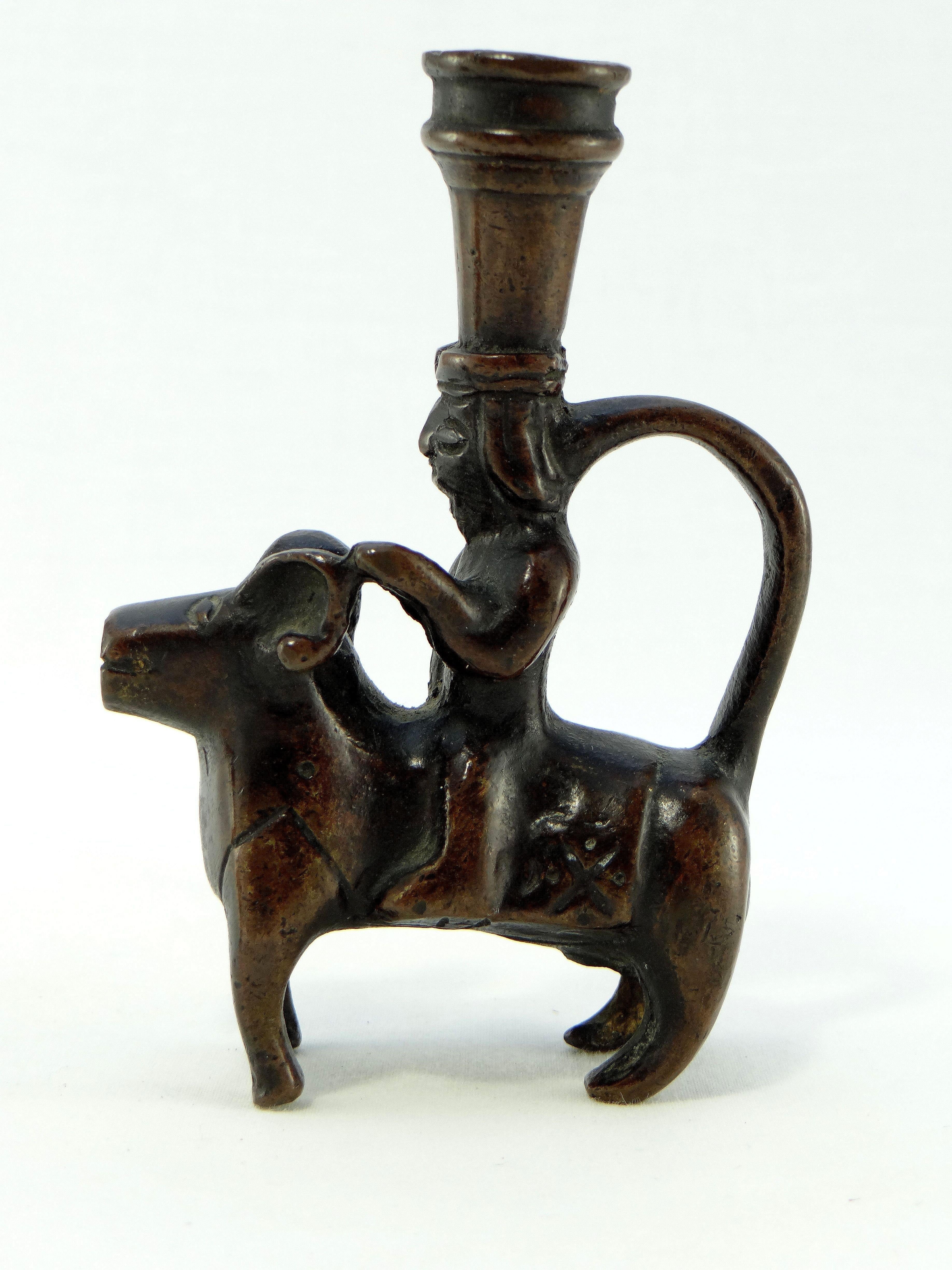 Islamic Iran 18th-19th Century, Pair of Bronze Candlesticks Characters on Rams For Sale