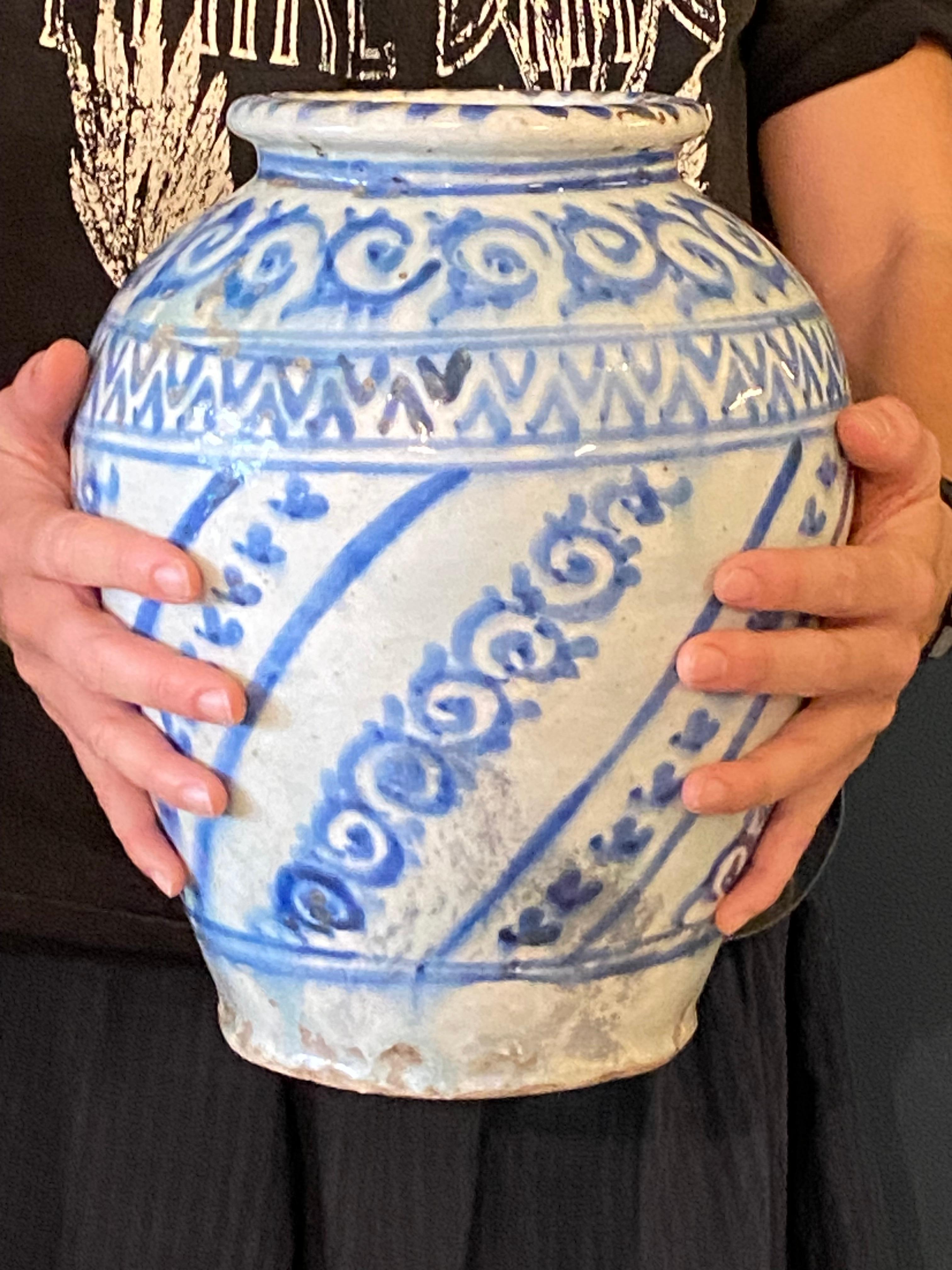 Très beau vase balustre safavide de la fin du XVIIe au début du XIXe siècle à décor tournant dans les tons bleus de motifs stylisés. En très bon état malgré un trou dans le fond. Légères rayures anciennes sur le col.