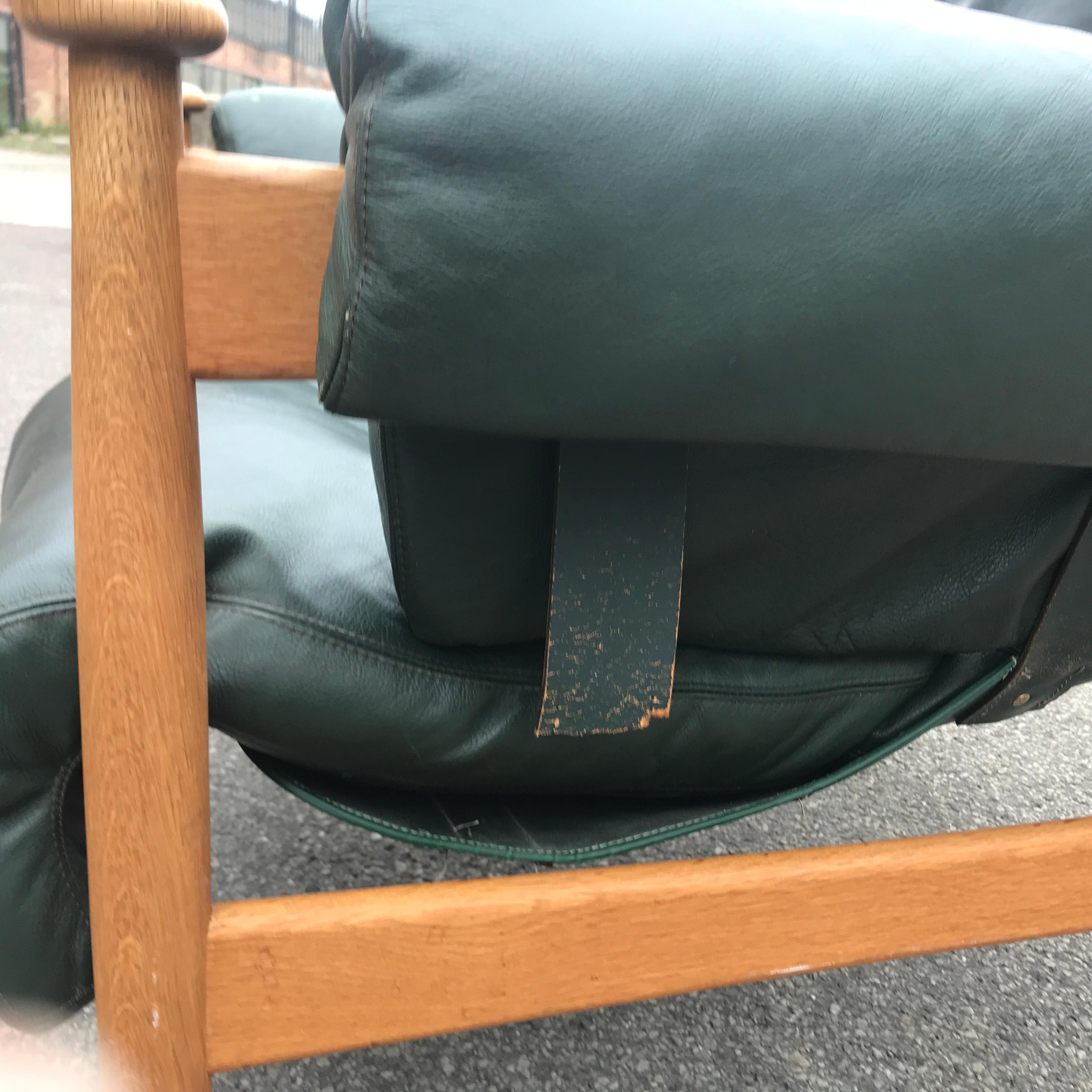 Timeless 1960s leather lounge chair designed by Eric Merthen for IRE Möbler in Sweden. This armchair is made of stained oakwood with dark green leather pillows.
Good condition with nice patina except for one leatherstrap that has to be restored.