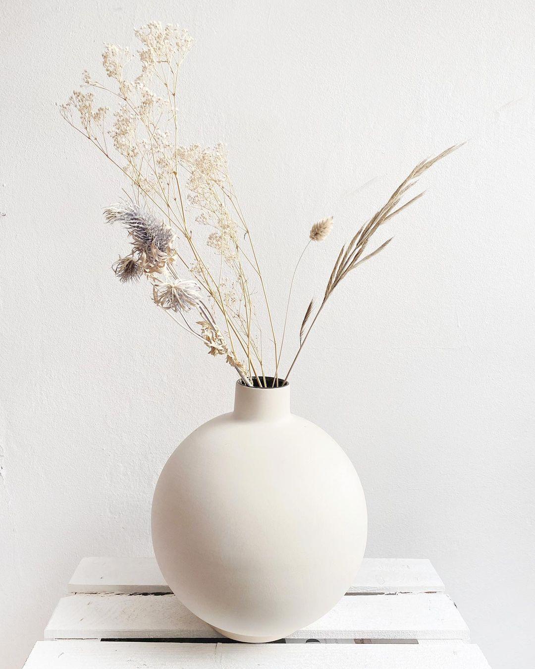 Irena black vase by Malwina Konopacka
Materials: Ceramic
Dimensions: ø 20 x 25 cm

Comes in a simple and compact spherical shape topped by a stout cylindrical neck. Made from non-refractory ceramics it offers great opportunities to exhibit