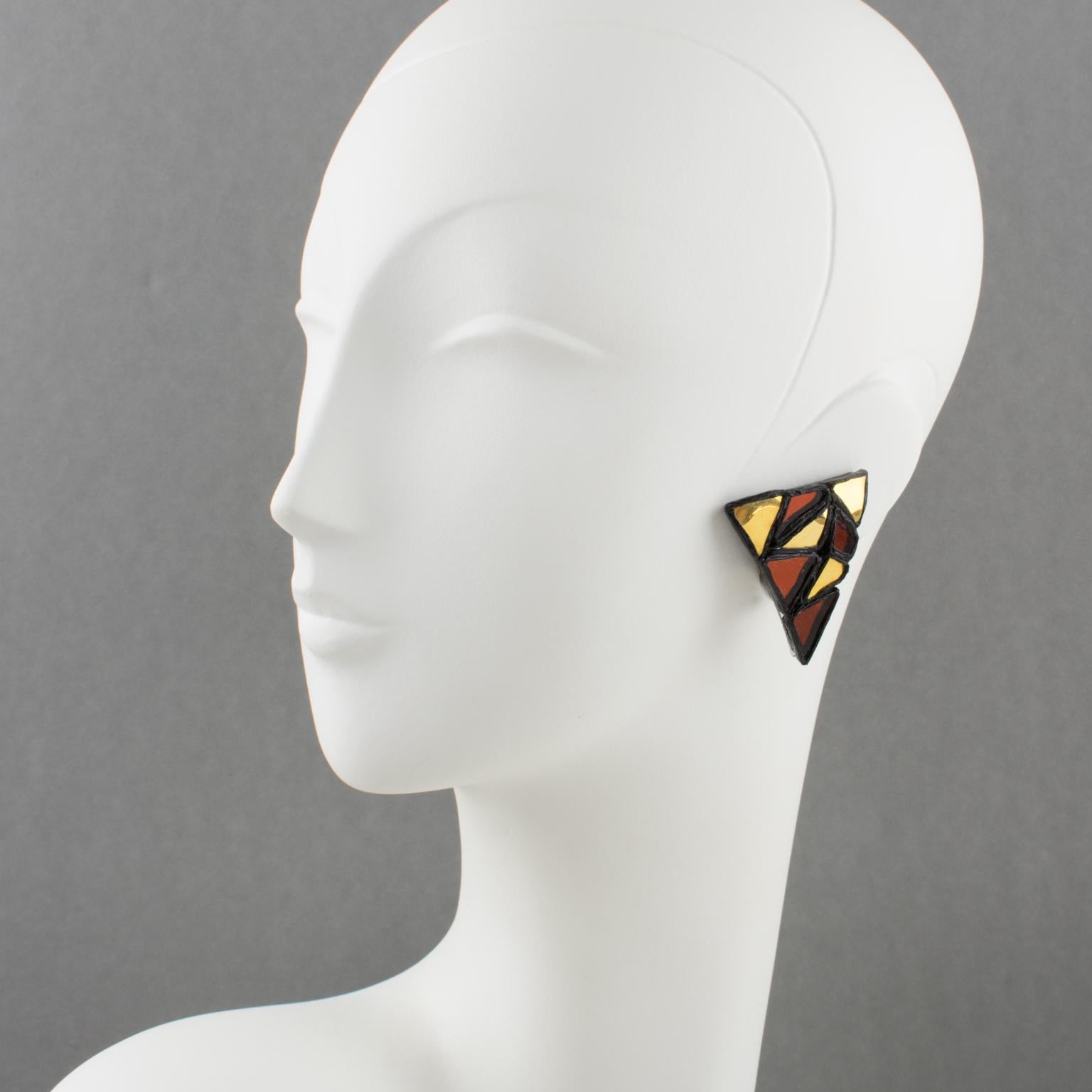 These exquisite Irena Jaworska Talosel or resin clip-on earrings feature a geometric triangle shape in black resin framing, topped with a mosaic of mirrors in gold and rust colors. Irena Jaworska is one of the Line Vautrin School students whose work