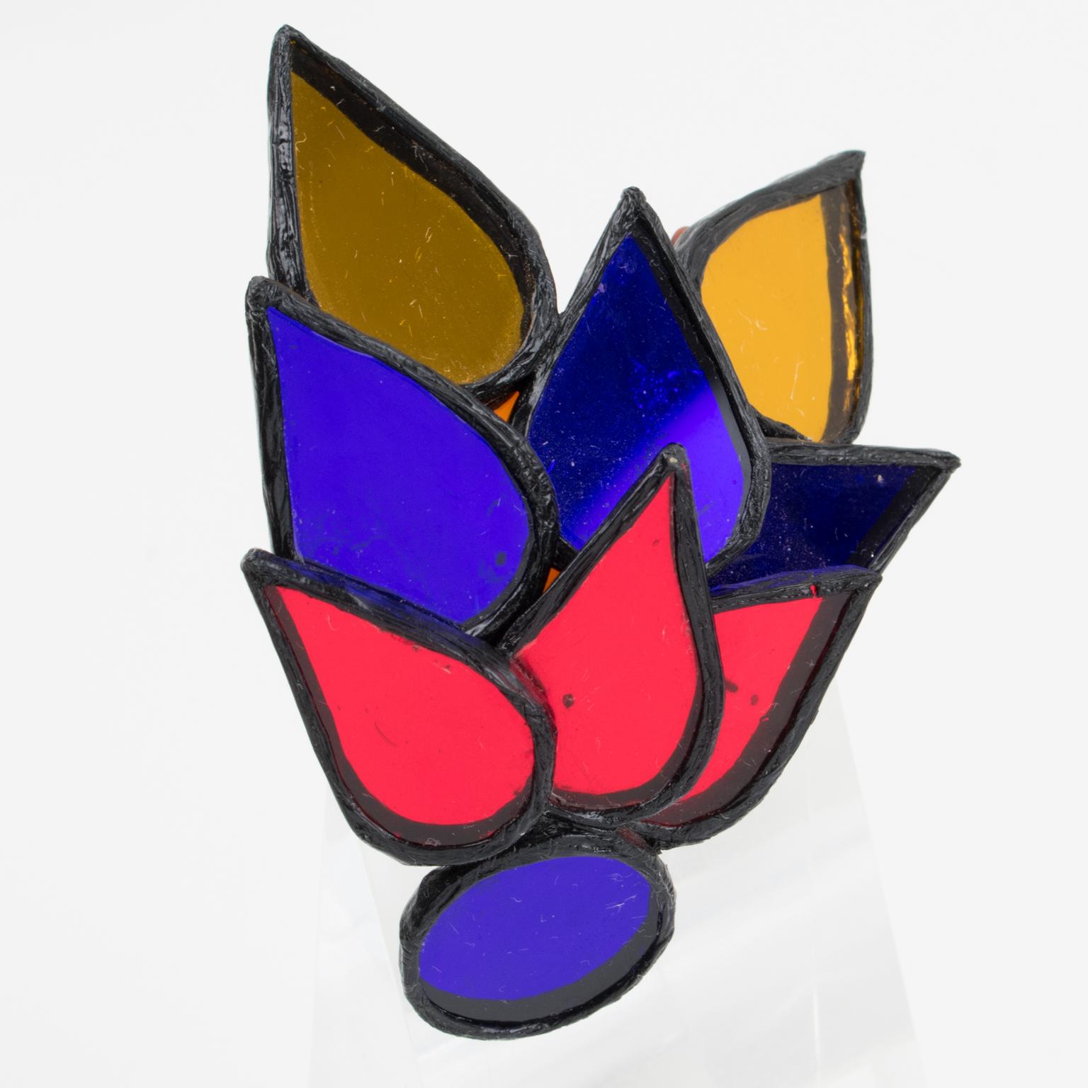 This is a marvelous Talosel or resin pin brooch designed by Irena Jaworska in the 1970s. The piece boasts a dimensional geometric bird shape in a black resin frame, topped with multicolored mirrors in ruby ​​red, cobalt blue, and saffron orange