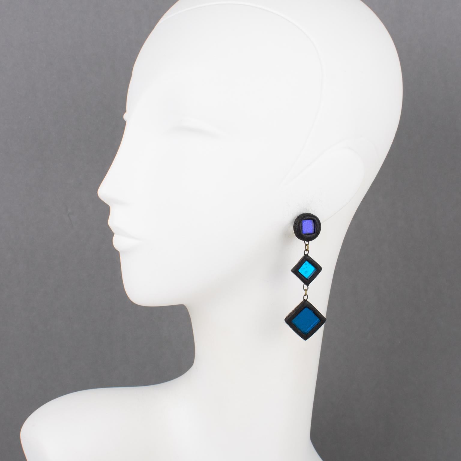 These gorgeous Irena Jaworska Talosel clip-on earrings feature a geometric square shape with black resin framing ornate with mirrors in cobalt blue and cerulean blue colors. Irena Jaworska is one of the Line Vautrin School students whose work has