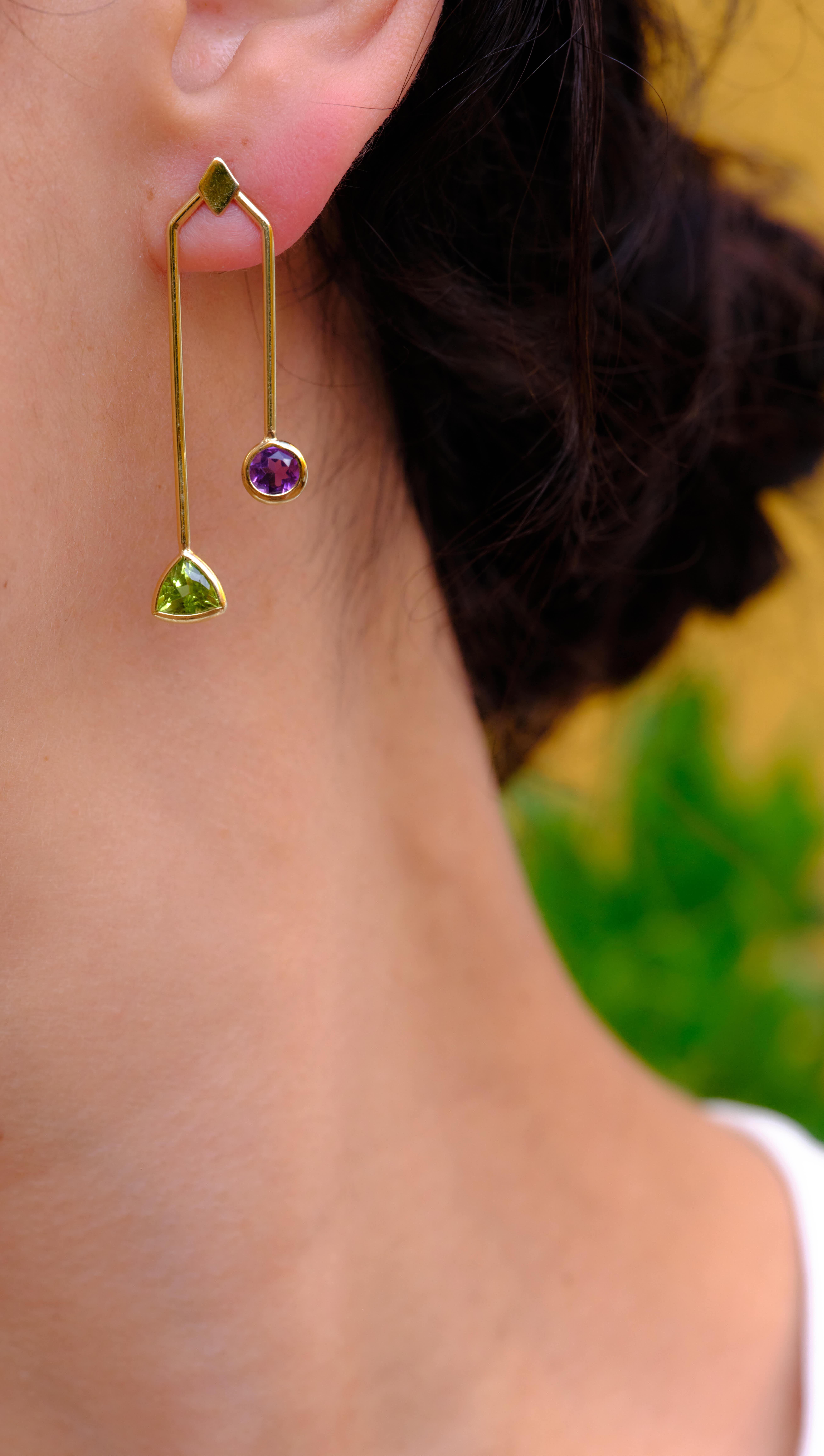 The combination of colors and shapes make simply unique this Malaka earrings.

•	Available color: yellow gold
•	18 Karat Recycled yellow Gold 
•	Weight: approx. 5 gr gold
•	Length: 45 mm
•	Amethyst 8×5 per cut and 5mm round cut
•	Peridot 5 mm