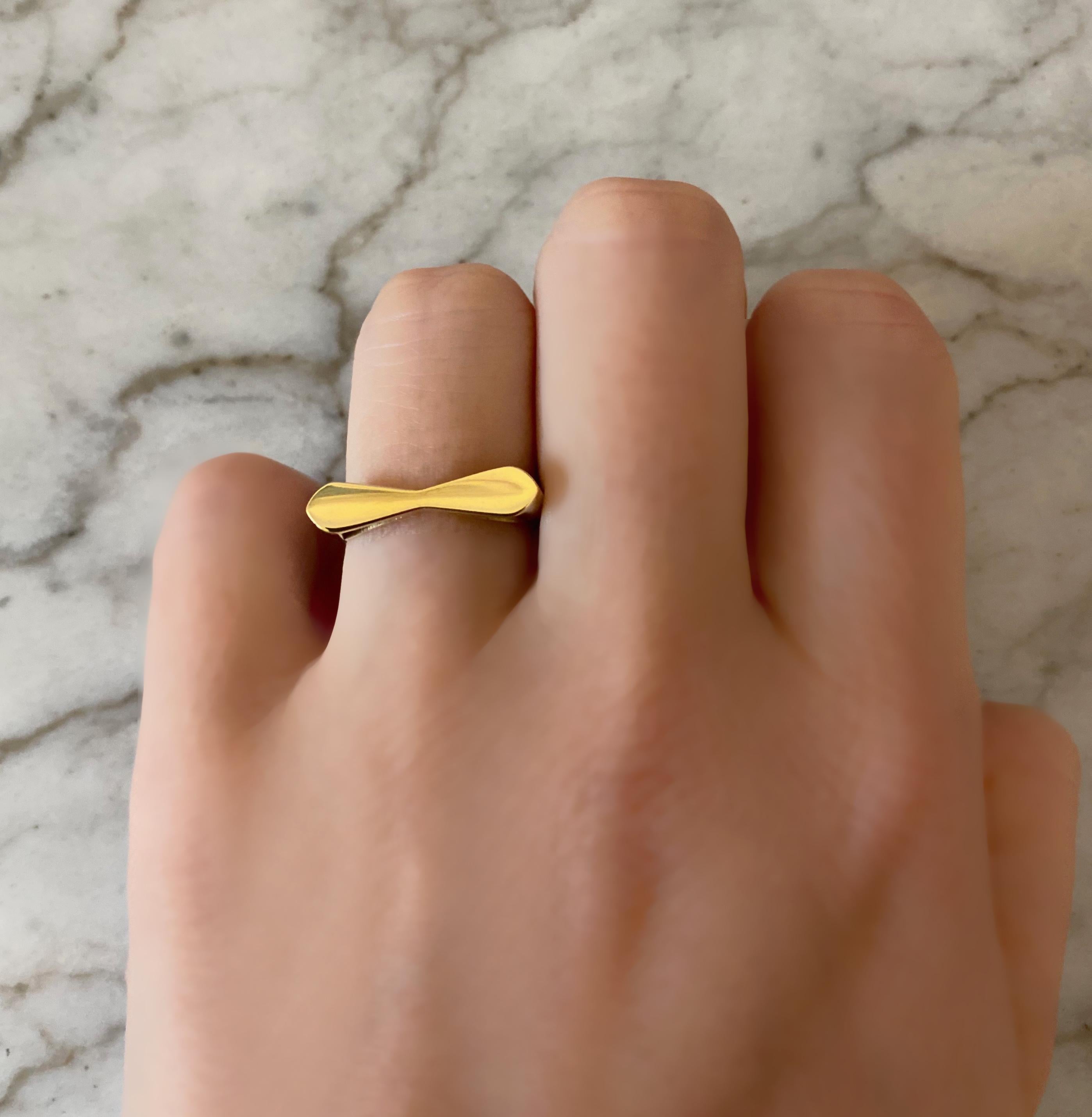 Comfy ring to combine with their Bracelet. Inspired by the figure of a tie. 

•	Available yellow gold in size 53 (EU) 6,6 (US), 16,8 mm
•	The size can be altered to fit

•	18 Karat Recycled Yellow Gold 
•	Weight: approx. 4 gr gold
•	Hand-made in