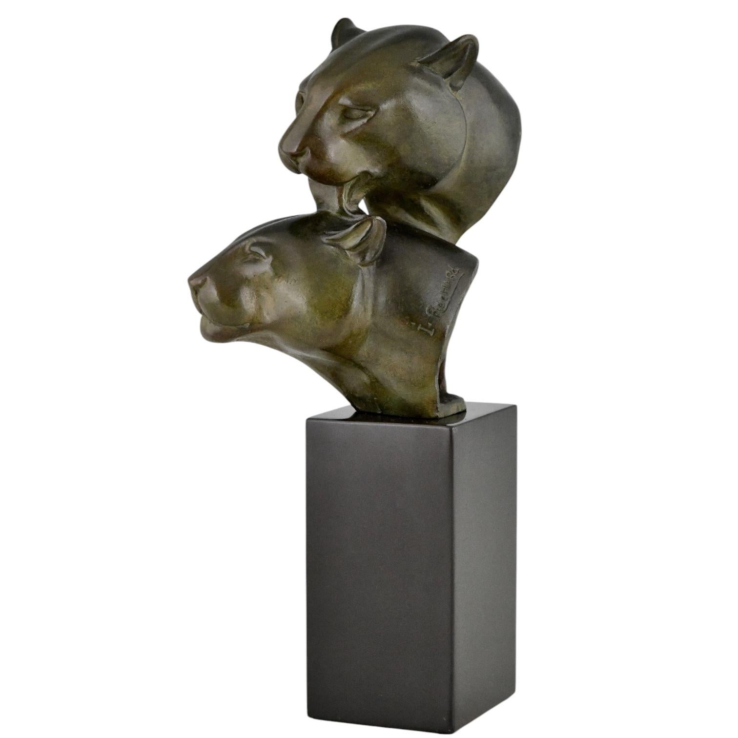 Bronzeskulptur aus dem Art déco mit zwei Pantherköpfen.