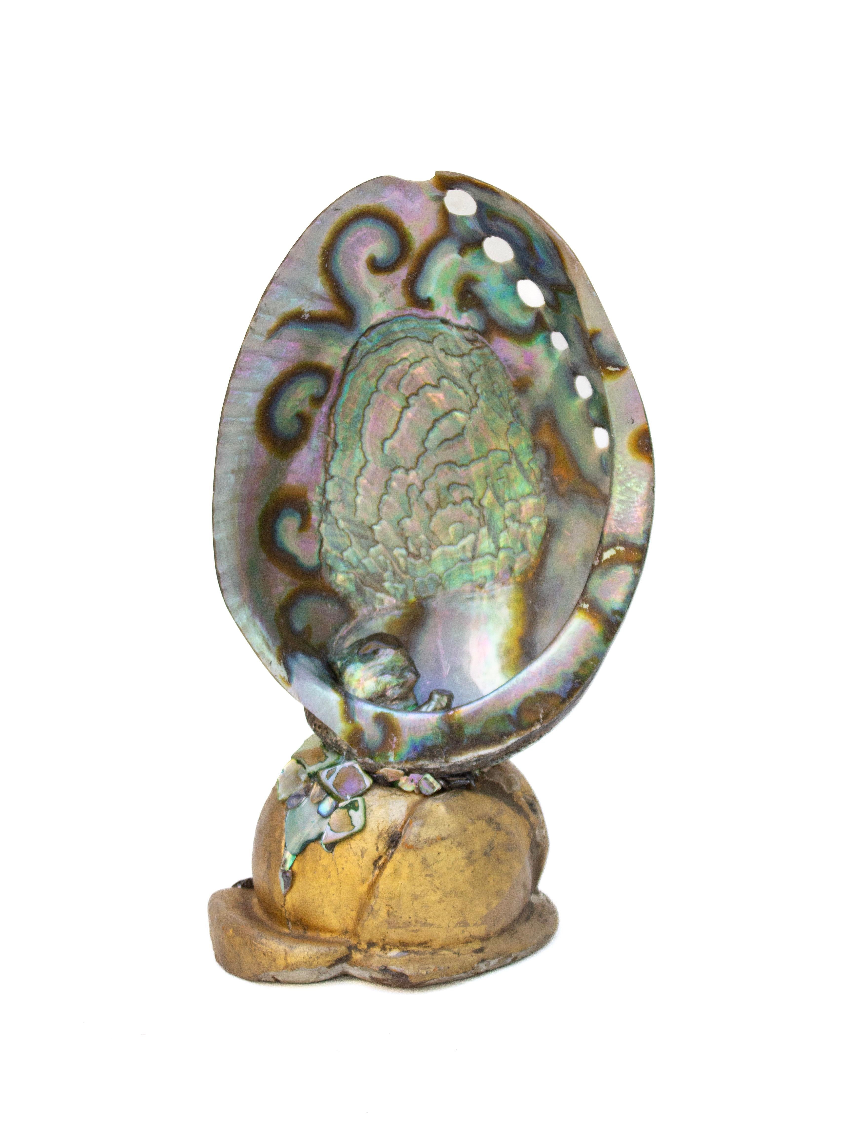 Iridescent abalone shell mounted on an 18th century Italian gilded and hand-carved base with baroque pearls.

Abalone shells or 