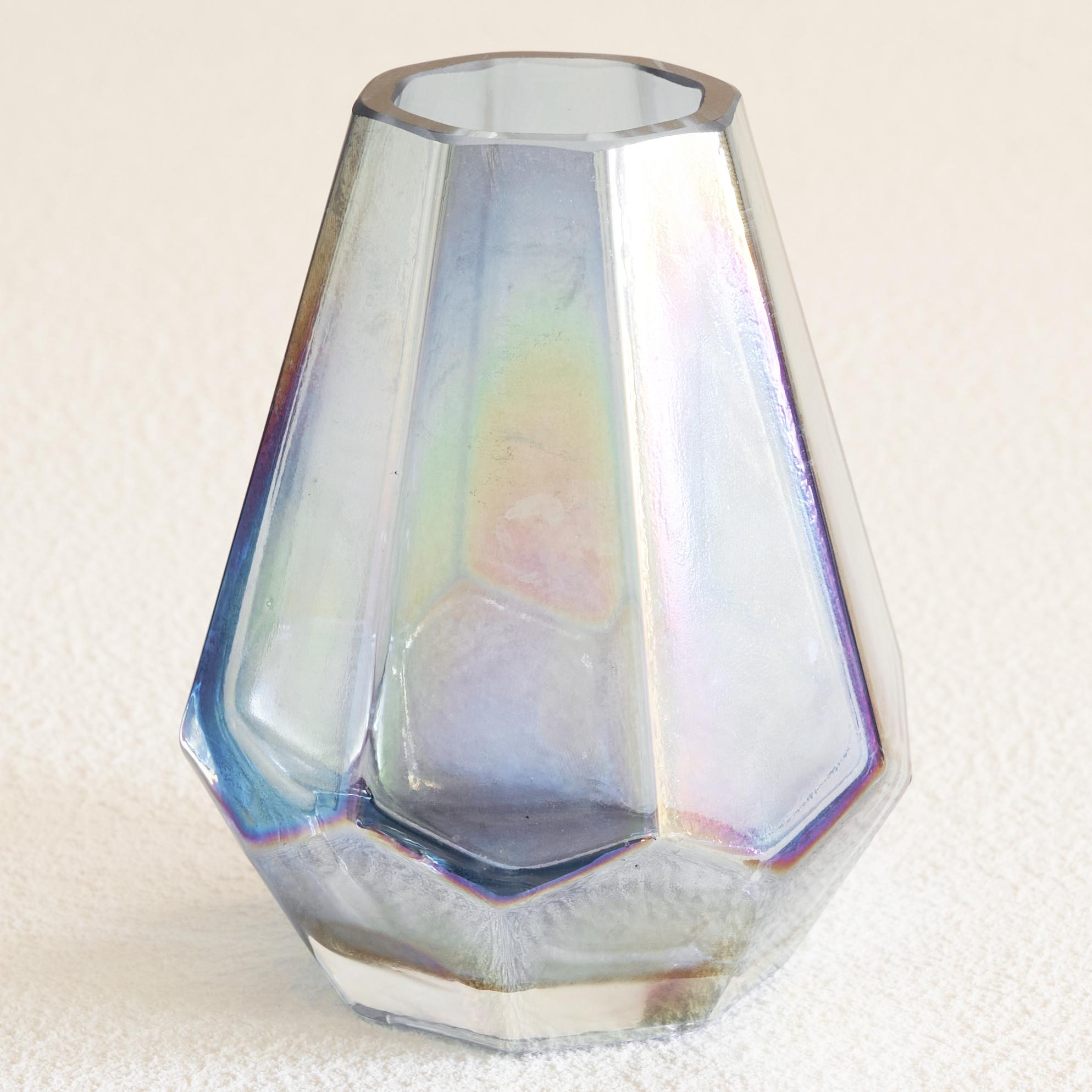 Iridescent Art Deco glass vase 1930s.

This is a very distinct and unique glass vase in iridescent pressed glass from the Art Deco period. This octagonal glass vase has a wonderful base shape, but the most interesting feature of this glass vase is