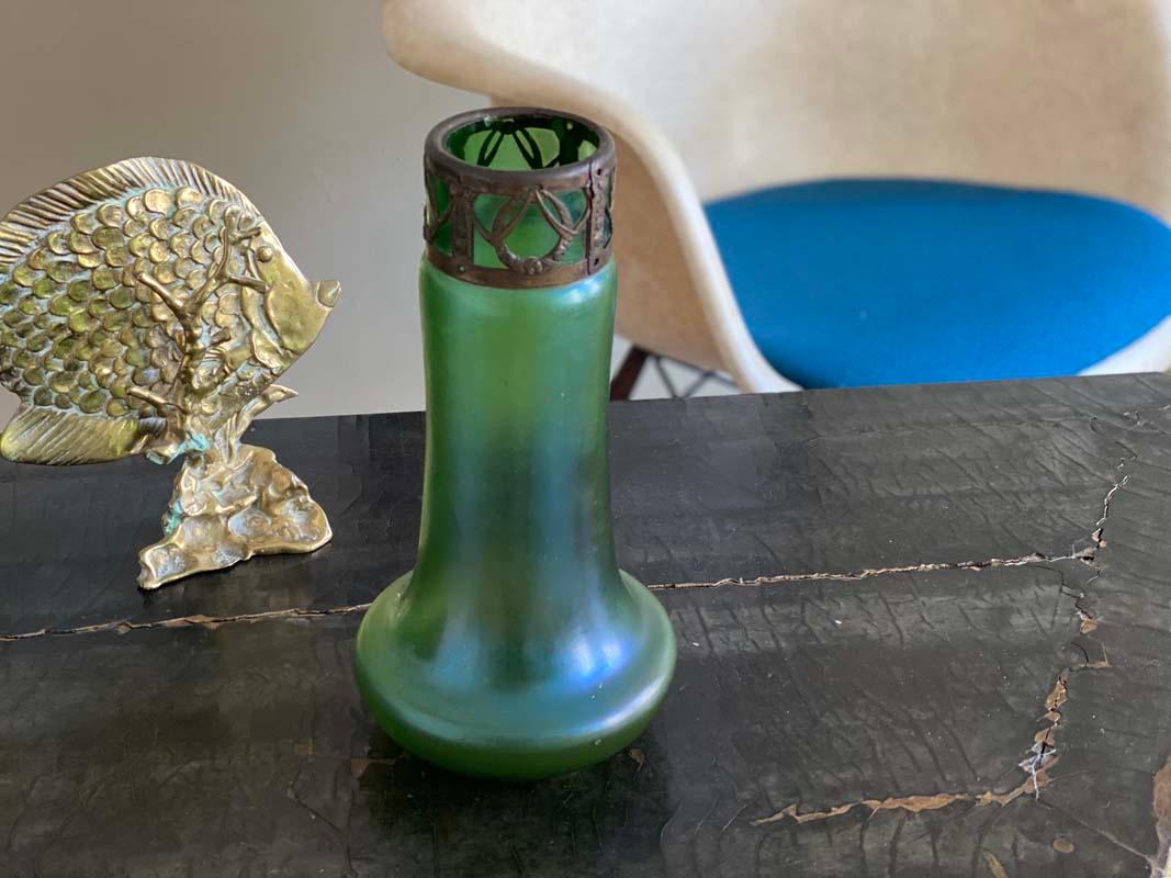 Typical Art Nouveau vase in the style of Loetz. The glass has a charming iridescent effect, at the top of the neck an elaborate and beautifully designed metal ornament in the form of a laurel garland encloses the vase. Laurels are among the typical