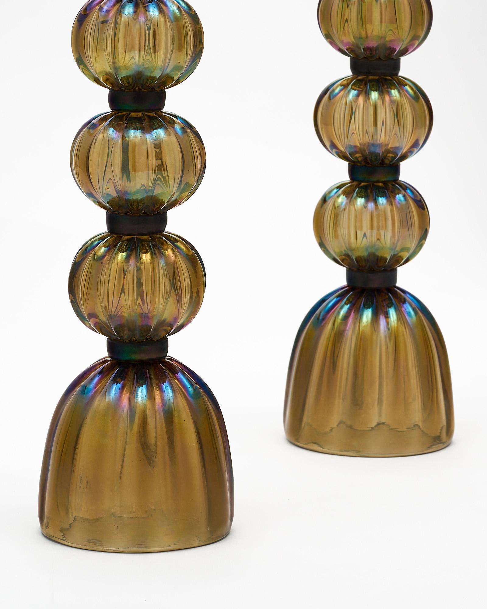 Pair of lamps from Murano, Italy made of hand-blown dark iridescent bronze colored glass. They have been newly wired to fit US standards.
