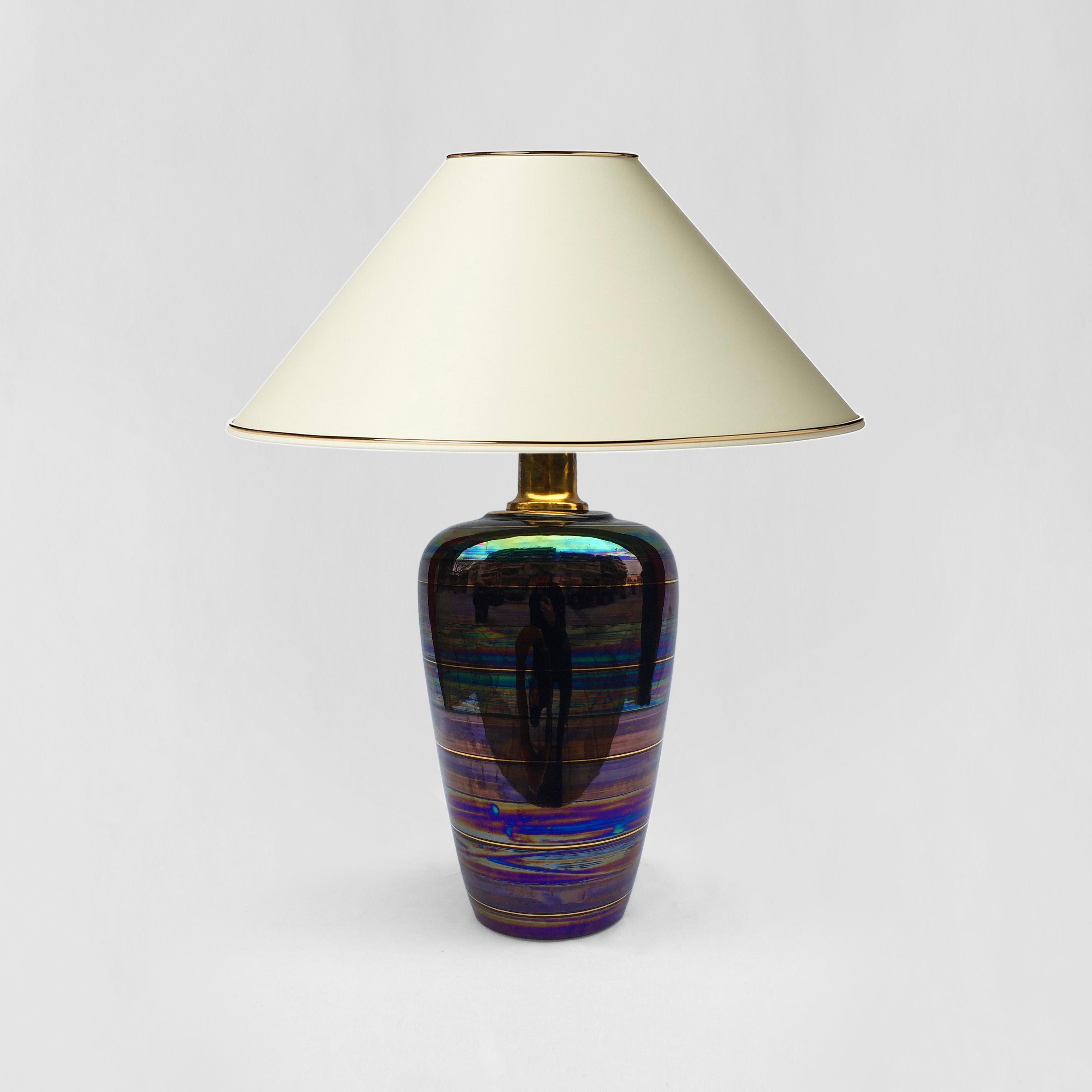 This alluring table lamp originates from the late 1970s, and is believed to have originated in the south of Italy. Composed entirely of ceramic, the vase-shaped base was dipped in to an iridescent paint mix before being glazed and hardened in the