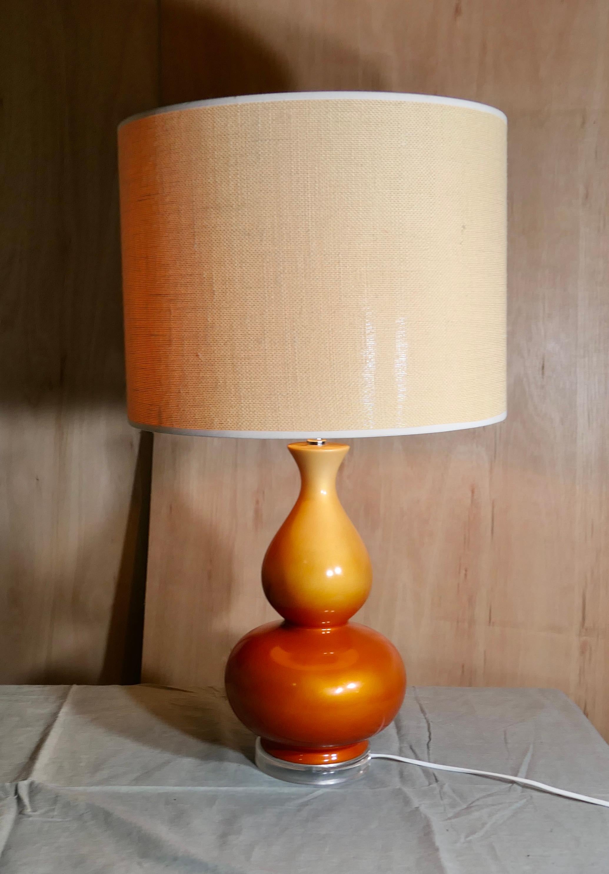 Iridescent Ceramic Table Lamp, Tangerine Dream with Linen Shade 

A superb piece of 1960s design on a solid clear base with an oversized Linen Shade
All in good working condition, the lamp is 32” tall, and 18” in diameter
CS248