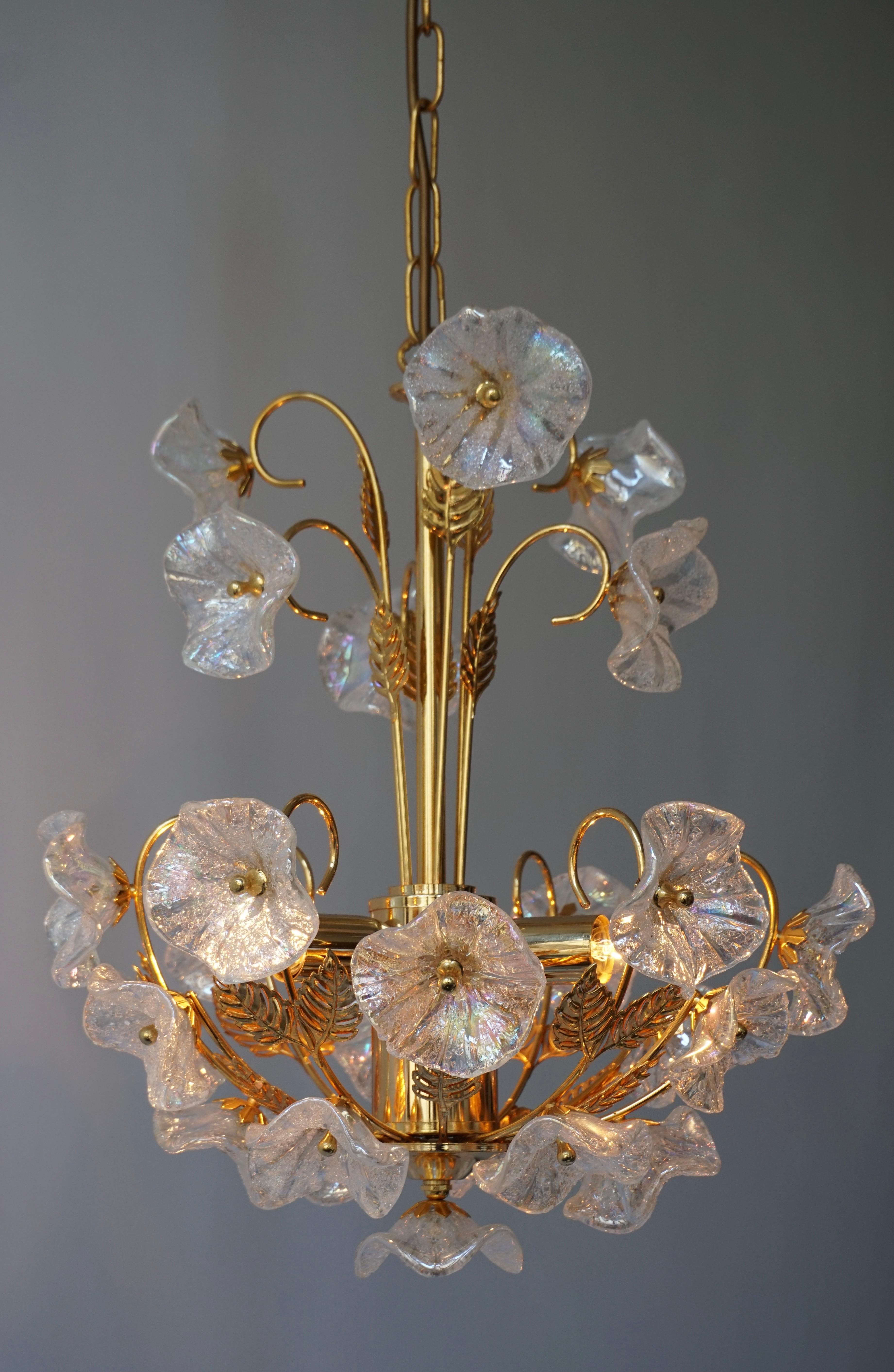 Iridescent Murano glass and brass floral chandelier.
Measures: Diameter 40 cm.
Height fixture 47 cm.
Total height including the chain and canopy 85 cm.
Three E14 bulbs.