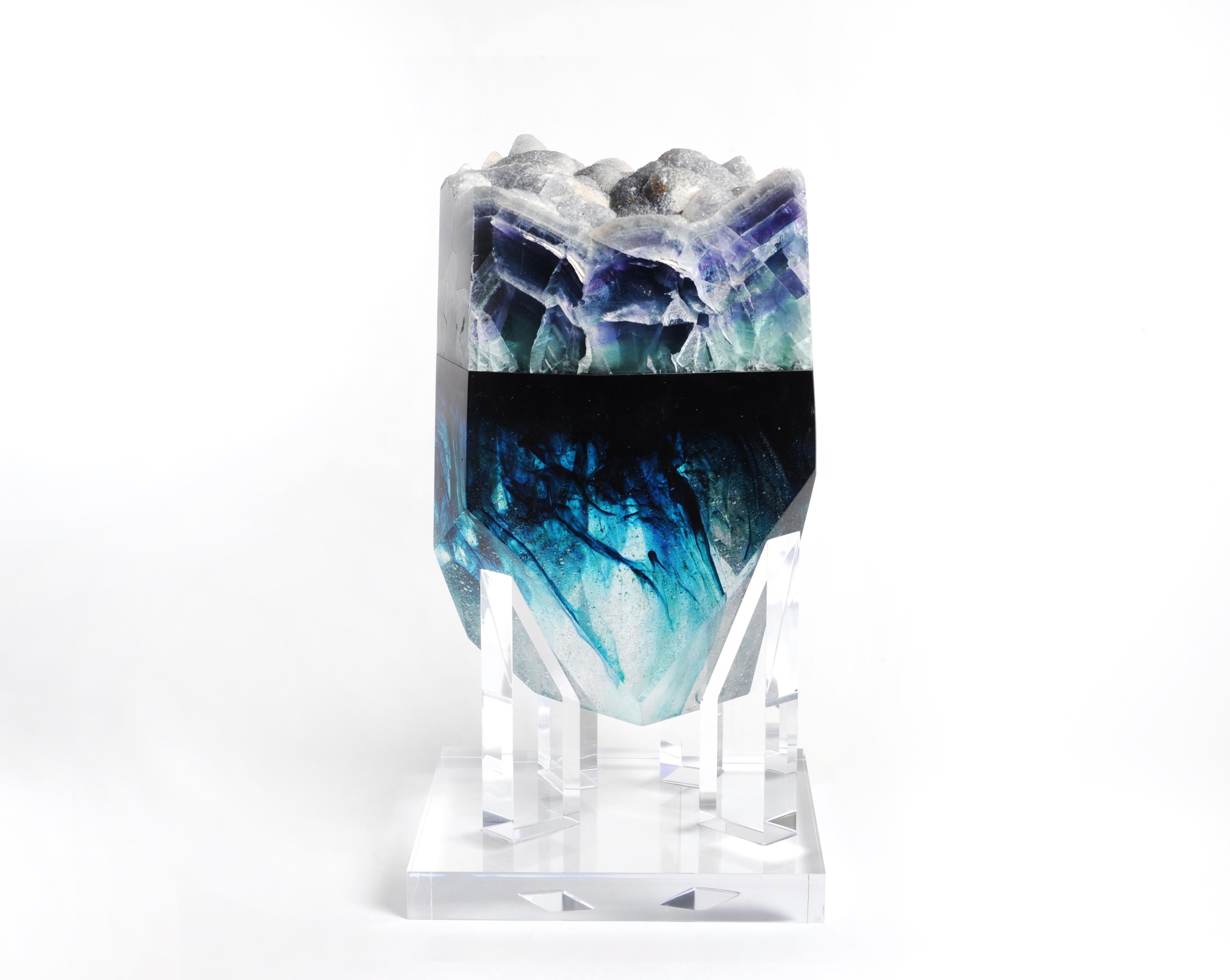 Krown Jewel
The movement of the ocean, the turquoise and deep blue hues contained in a magnificent irregular prism of glass only deserve to be crowned by one of the most mysterious minerals in the world, the fluorite. This natural specimen from San