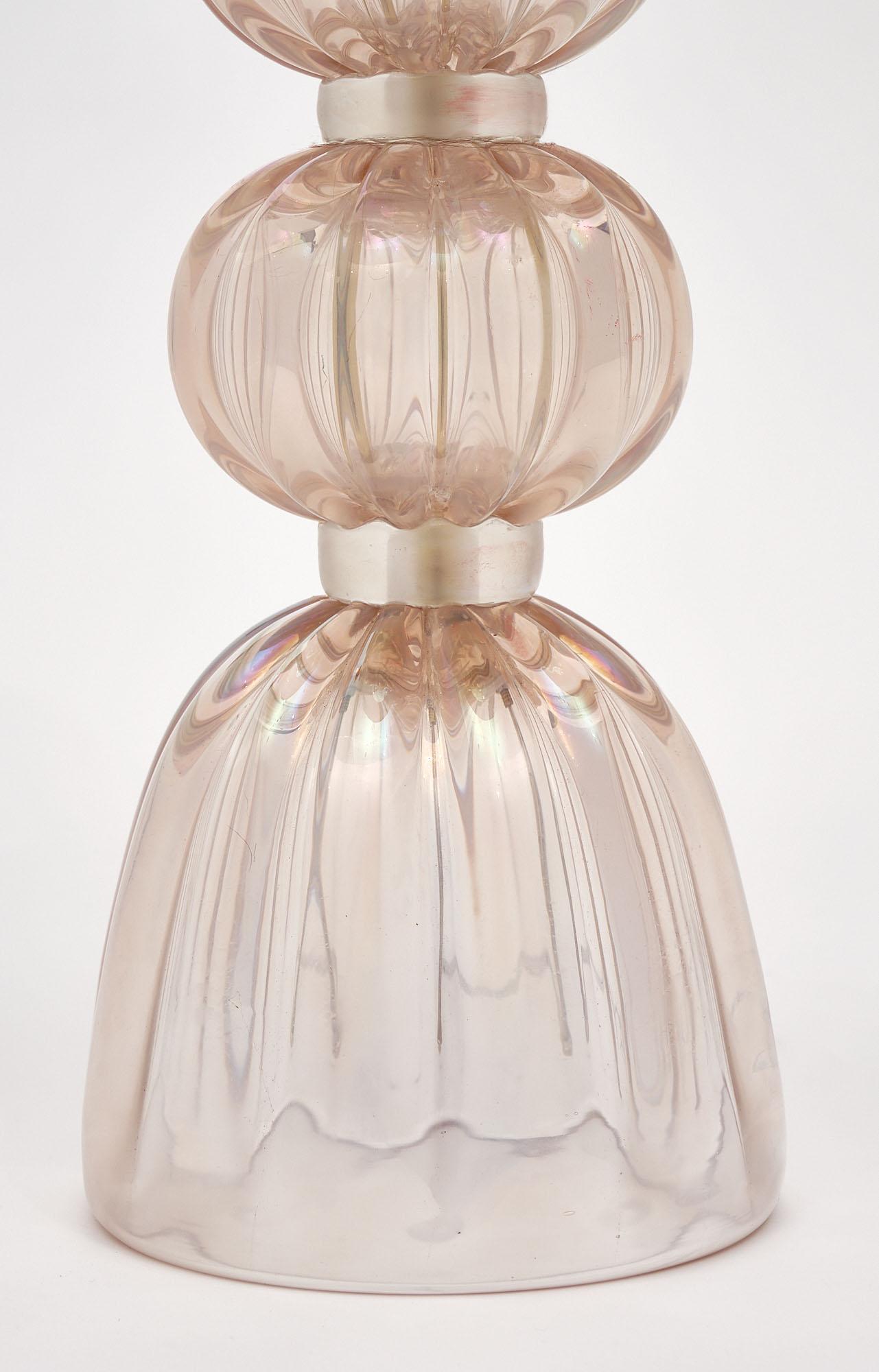 Single lamp from Murano; Italy made of hand-blown iridescent glass in a light pink color. It has been newly wired to fit US standards. Signed Alberto Dona.