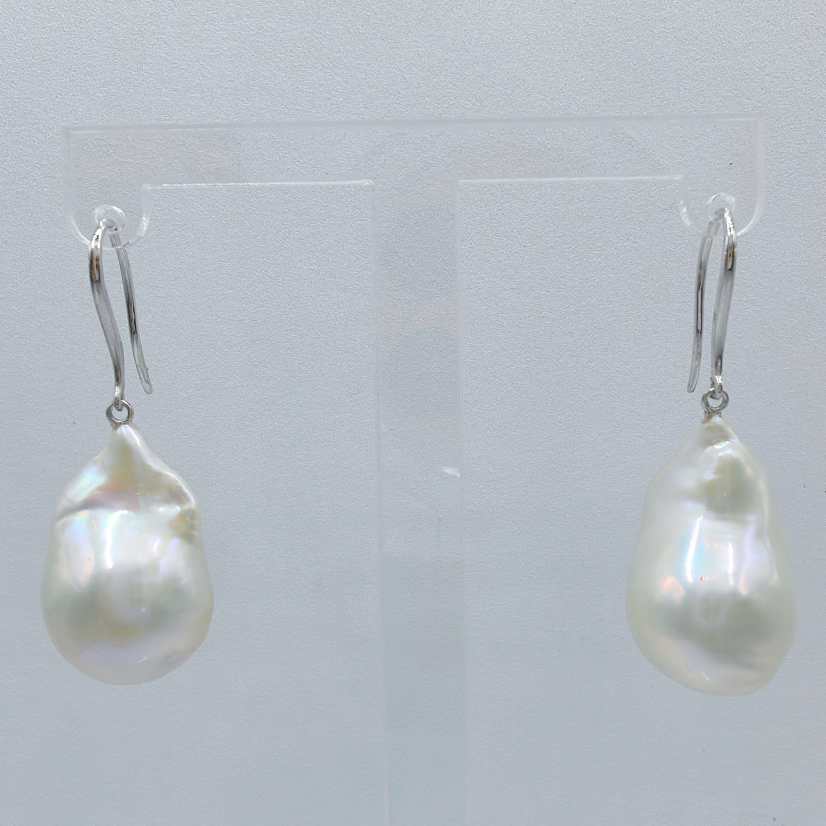 Indulge in the alluring grace of our Iridescent Baroque Pearl Drop Earrings, crafted to captivate and inspire. These remarkable earrings feature stunning Freshwater Cultured Baroque Pearls, boasting a brilliant white hue with a delicate iridescent