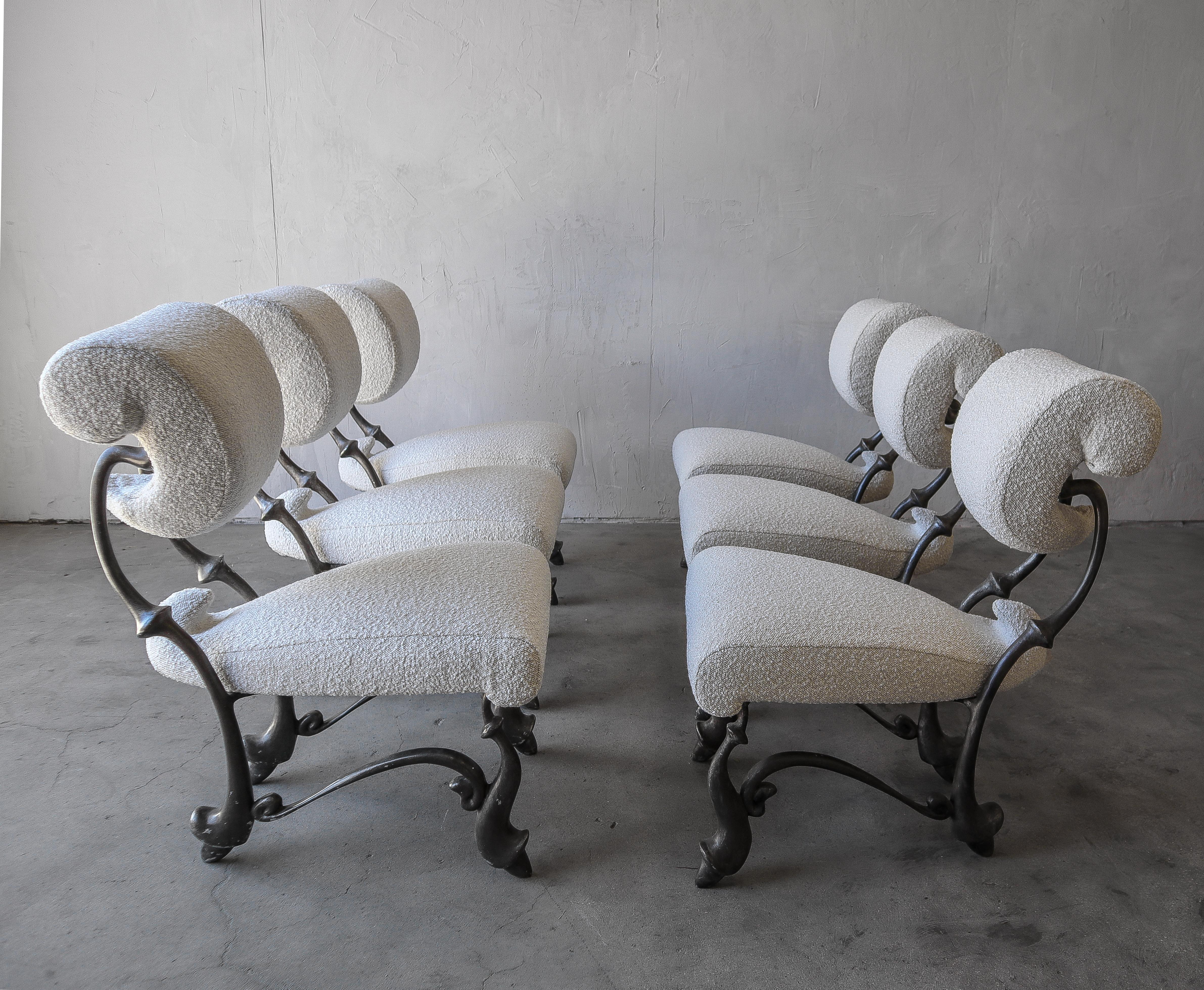 Absolutely incredible set of 6 Iridium ballet chairs, by Jordan Mozer. These chairs were created for the Iridium restaurant in New York in 1992. Cast out of solid, recycled aluminum-magnesium alloy, and upholstered in all new boucle
