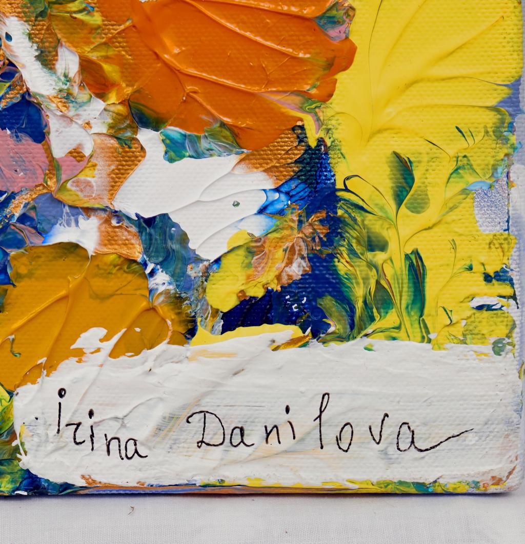 This vibrant artwork is an explosion of color and texture, showcasing a dynamic interplay of bold, expressive brushstrokes. The composition is anchored by a dominant palette of blues, interspersed with striking splashes of orange and hints of