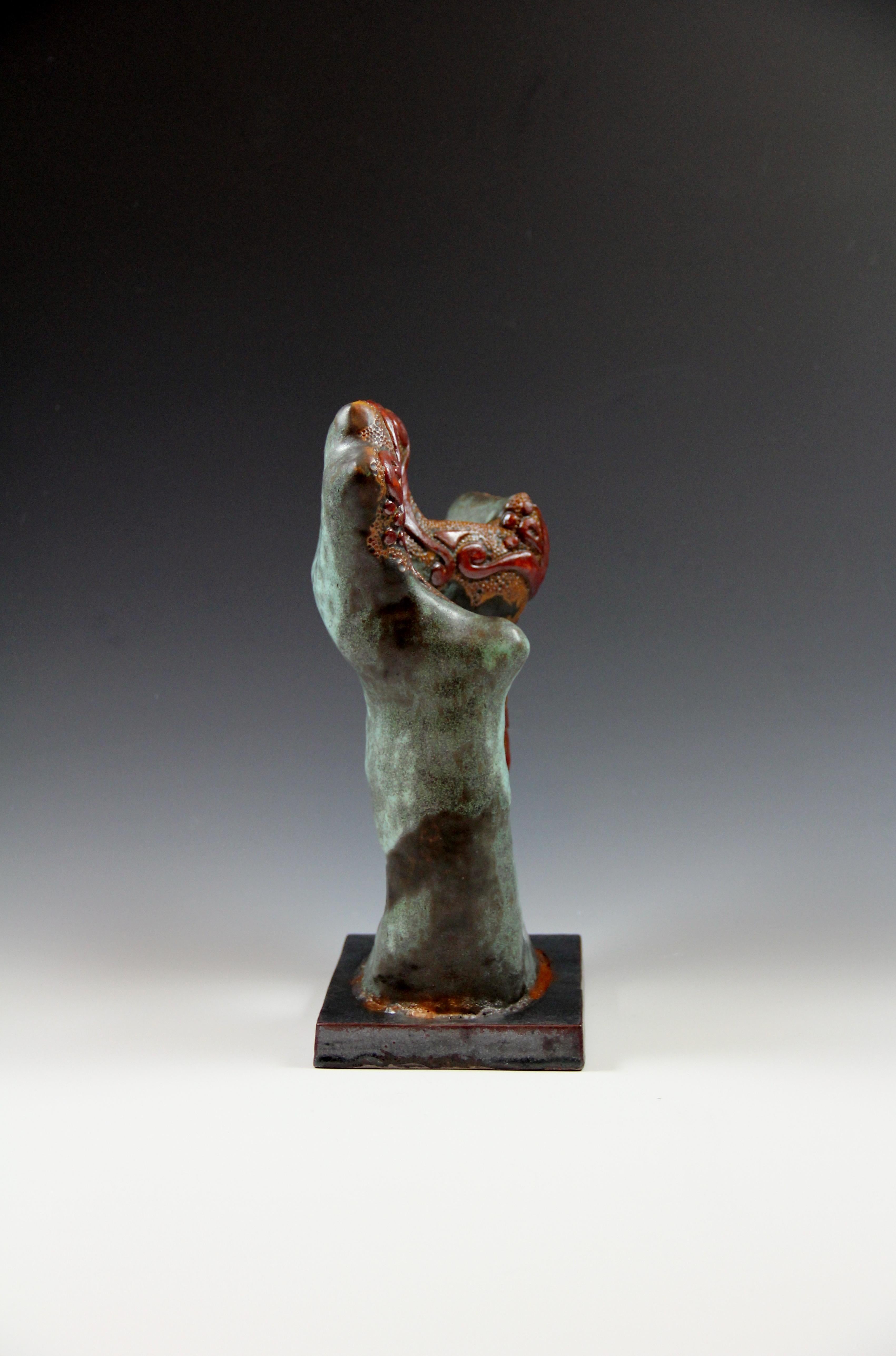 These two sculptures were hand build with clay, carved, glazed and fired twice. The base is also made with clay and attached.
Dimensions
9 W x 14 H x 5 D  

Irina Deshchenko-Lakshin was born and raised in Petropavlovsk-Kamchatsky, the capital of the