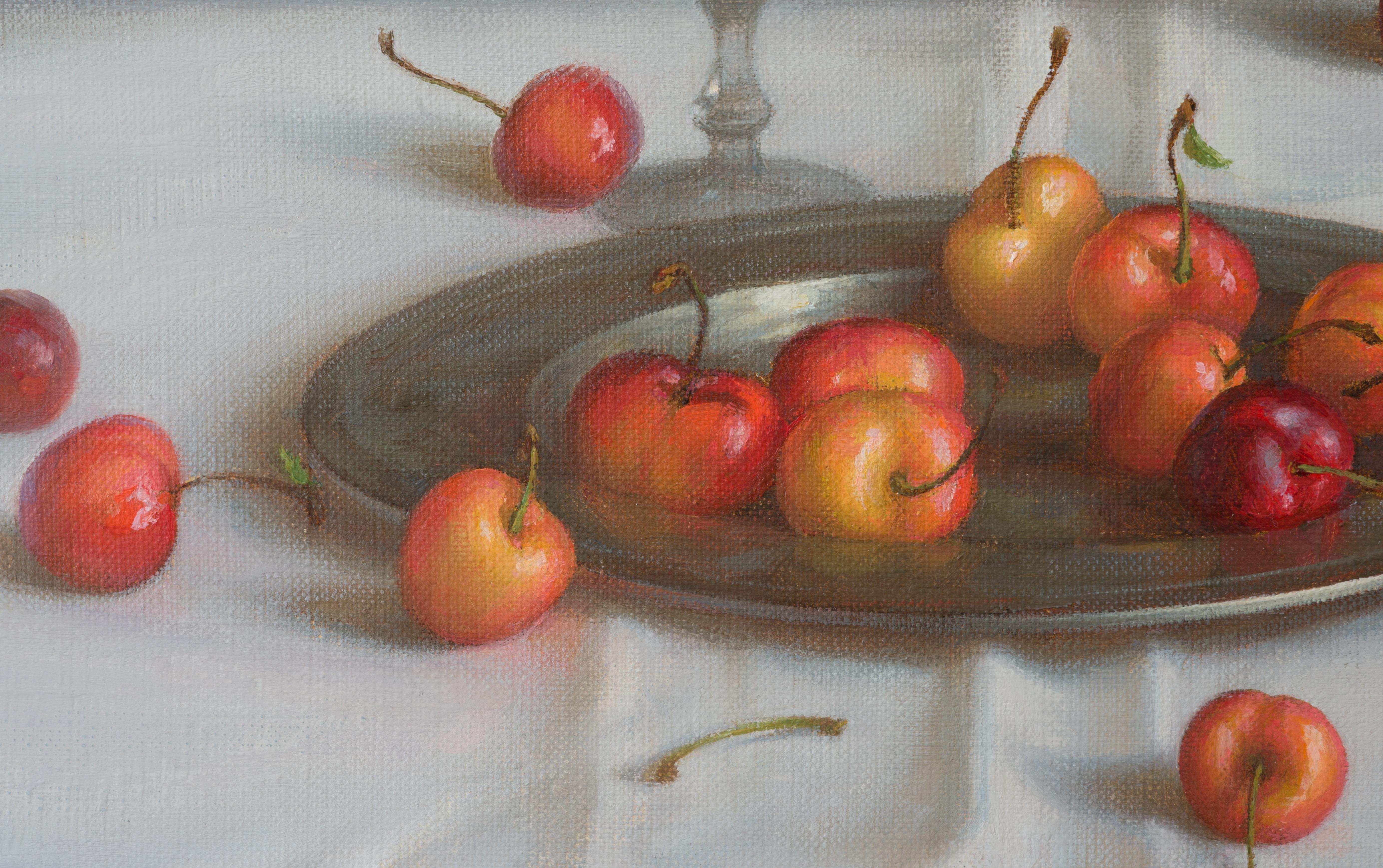  Scattered cherry on the metal plate create a vivid contrast against the white tablecloth focusing the viewer's eye towards the center of the composition. The various shades of red and yellow and the choice of details made it possible to convey the