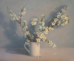 Flowering branches in a white mug