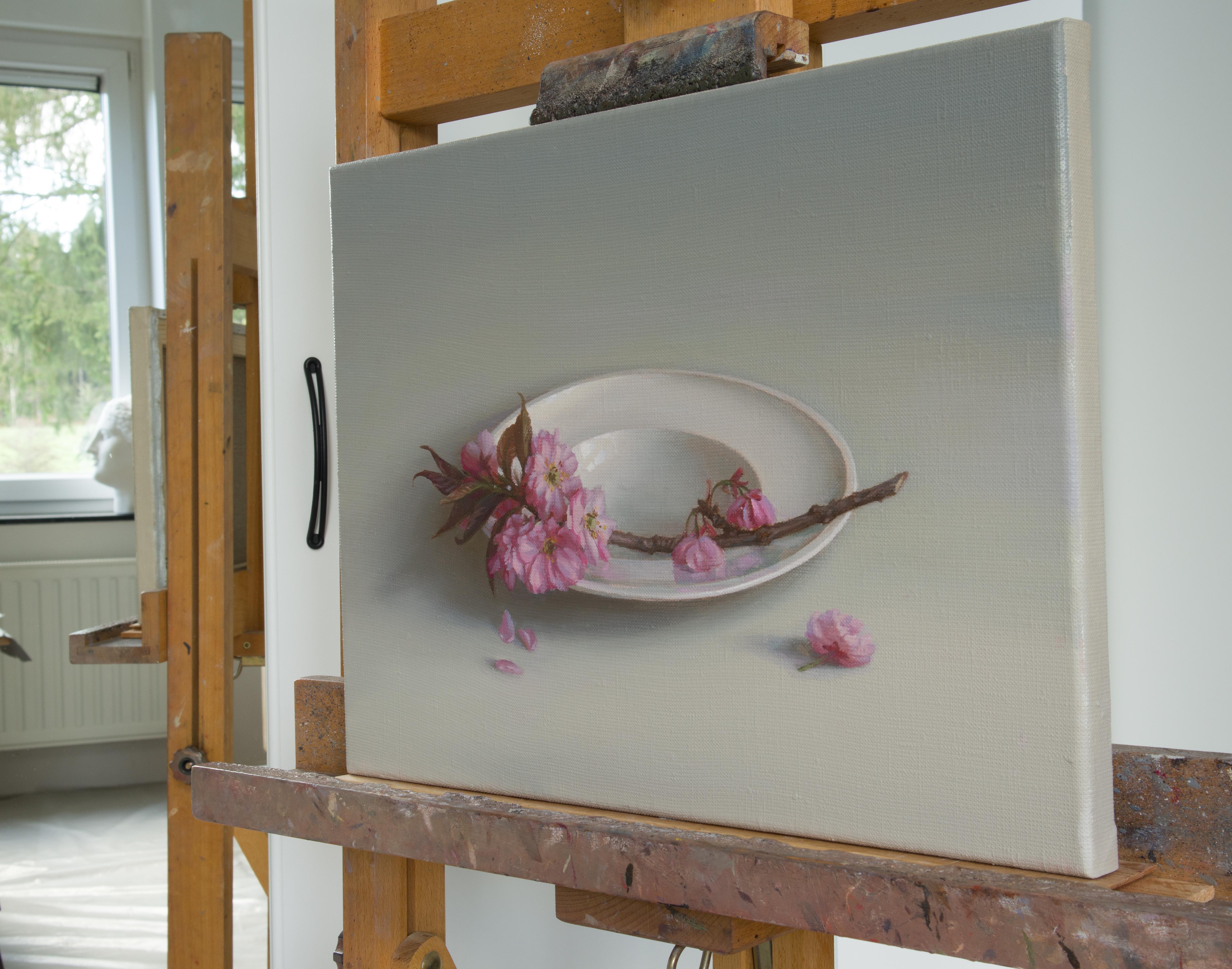 A cherry branch is placed in a smooth, neutral space. The various shades of pink color of flowers with its thin delicate petals inspire me to create this work. My intention was to keep tenderness and preciousness of flowers, a quality I wanted to