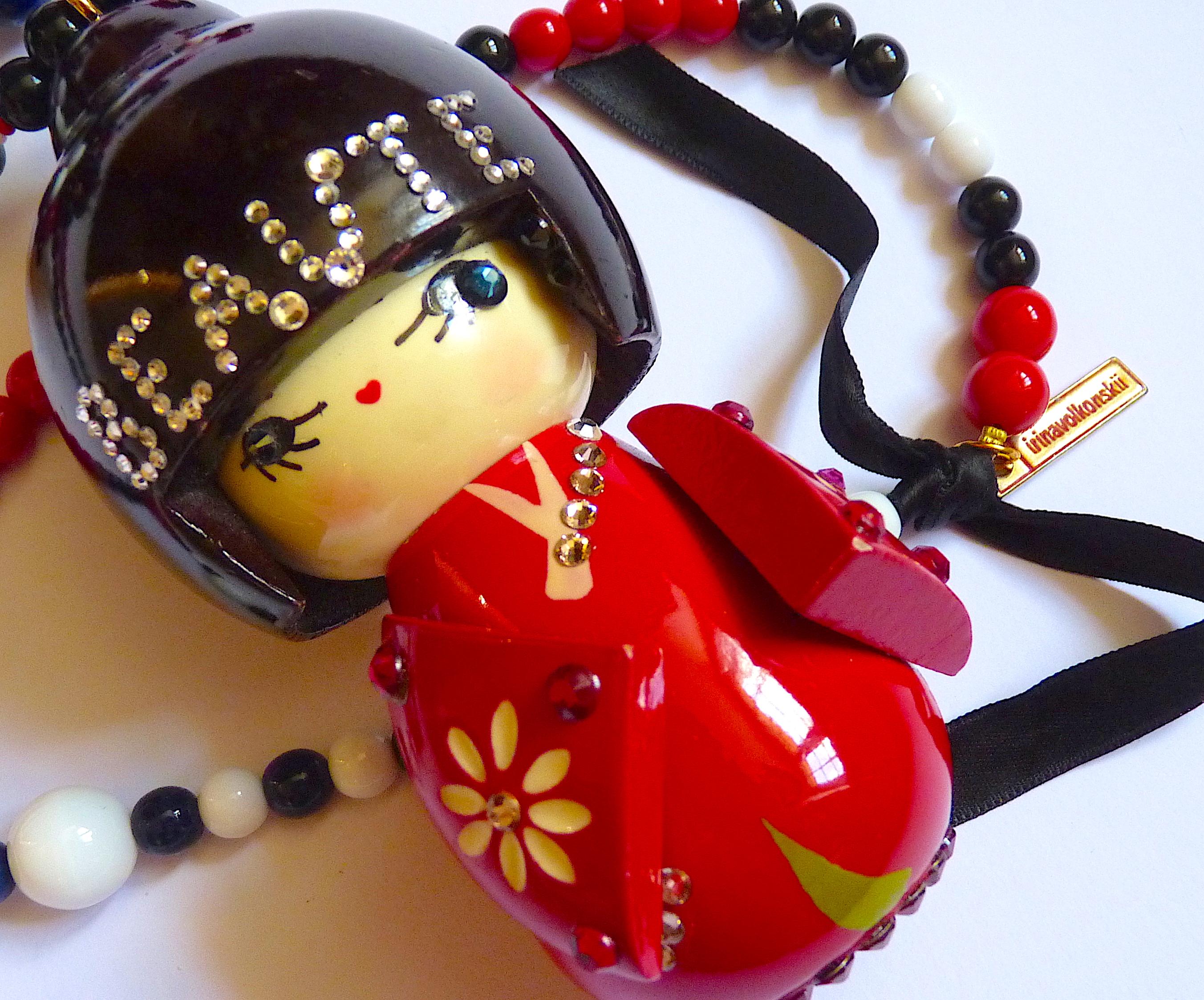 Ultra Rare Irina Volkonskii  for Paul Smith London, Very Long Pendant Necklace, made of Blue, White, Red, Black pearls with a Large Geisha Doll  Pendant adorned with rhinestones and the word BEAUTY .

IRINA VOLKONSKII is a russian born artist,