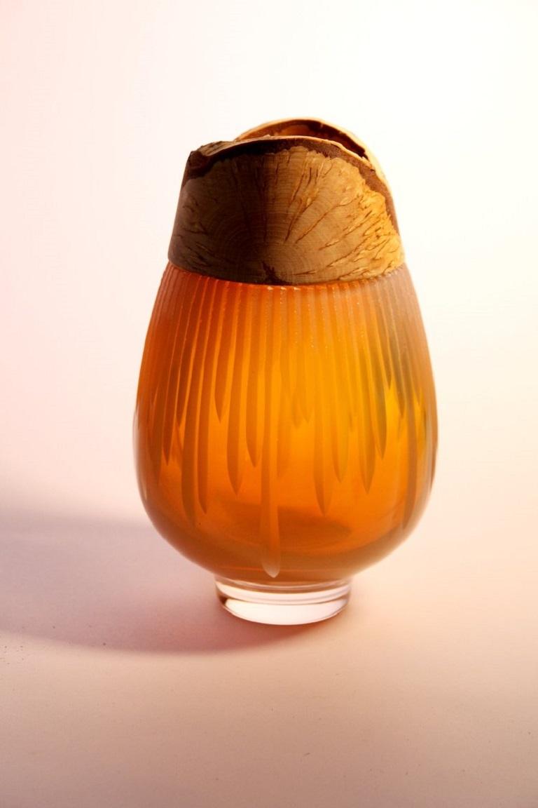 Iris Amber Frida with cuts stacking vessel, Pia Wüstenberg
Dimensions: D 13 x H 20
Materials: cut glass, wood

With its sculpted glass topped by Curly Birch, Poppy is an exquisite vessel. This delightful piece finds heritage in the refined