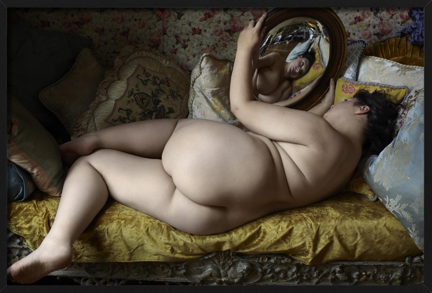 Beauty 009 - Nude on a Yellow Sofa with Mirror, Fine Art Photography - Black Color Photograph by Iris Brosch