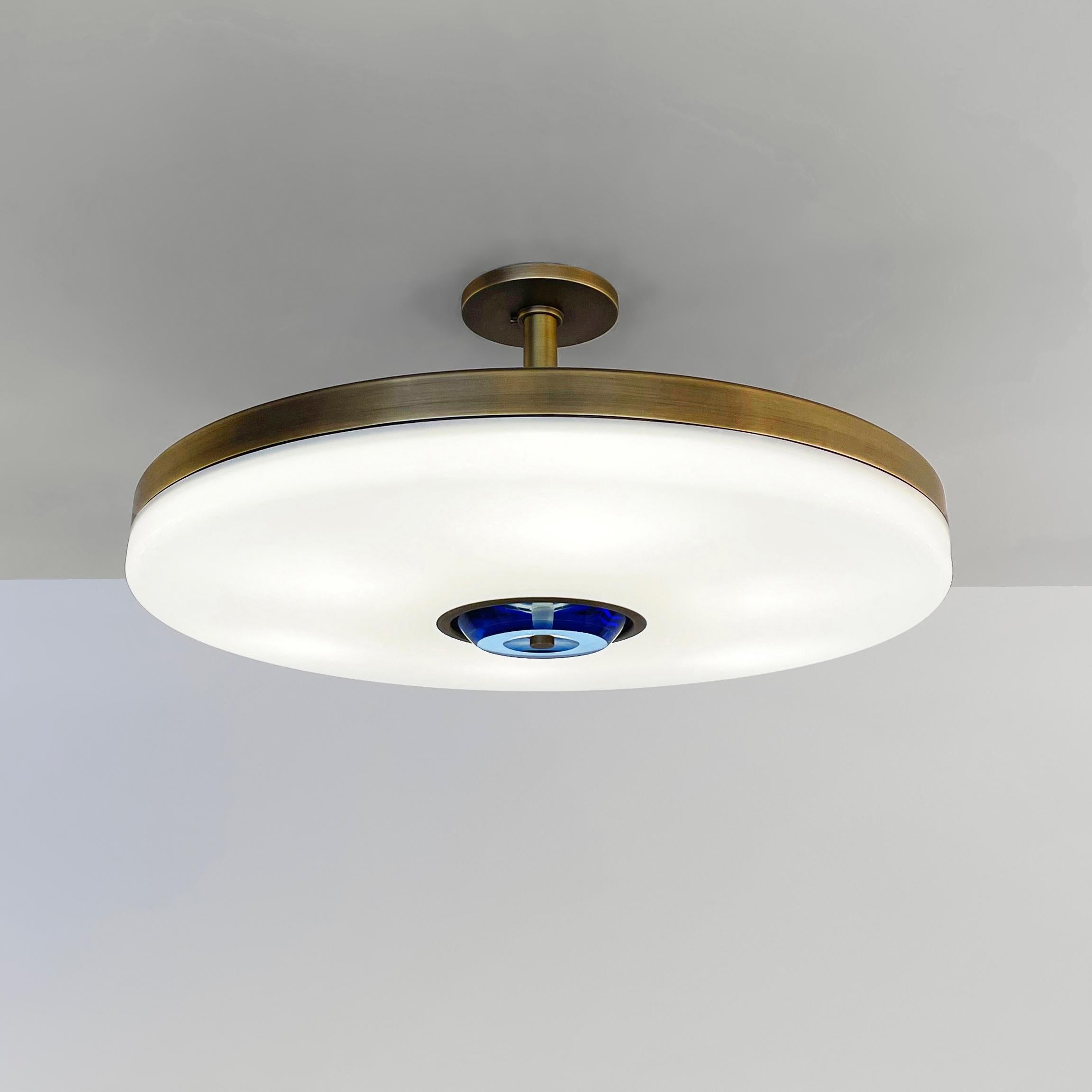 The Iris ceiling is designed around an expansive acrylic shade with a hand carved glass center. This versatile fixture can be installed as a pendant on a stem or as a true flush mount. The first images show the fixture in our Bronzo Ottone (Bronze)