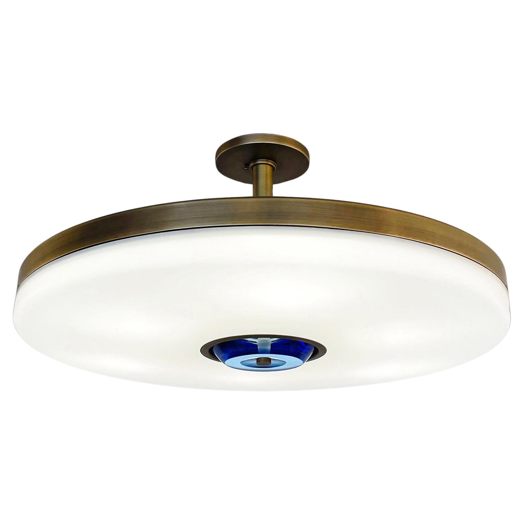 The Iris ceiling is designed around an expansive acrylic shade with a hand carved glass center. This versatile fixture can be installed as a pendant on a stem or as a true flush mount. The first images show the fixture in our Brunito Nero (black
