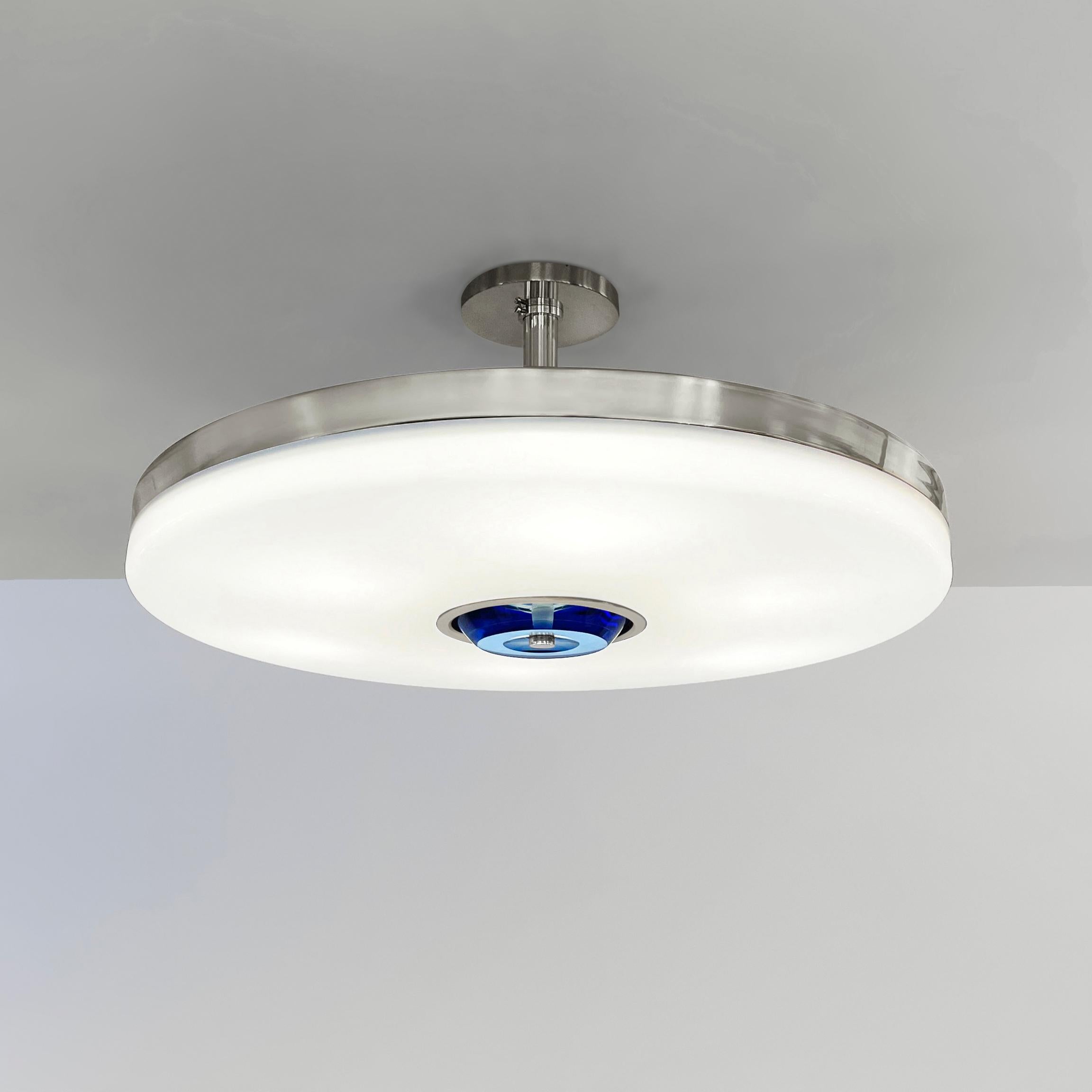 The Iris ceiling is designed around an expansive acrylic shade with a hand carved glass center. This versatile fixture can be installed as a pendant on a stem or as a true flush mount. The first images show the fixture in our polished nickel