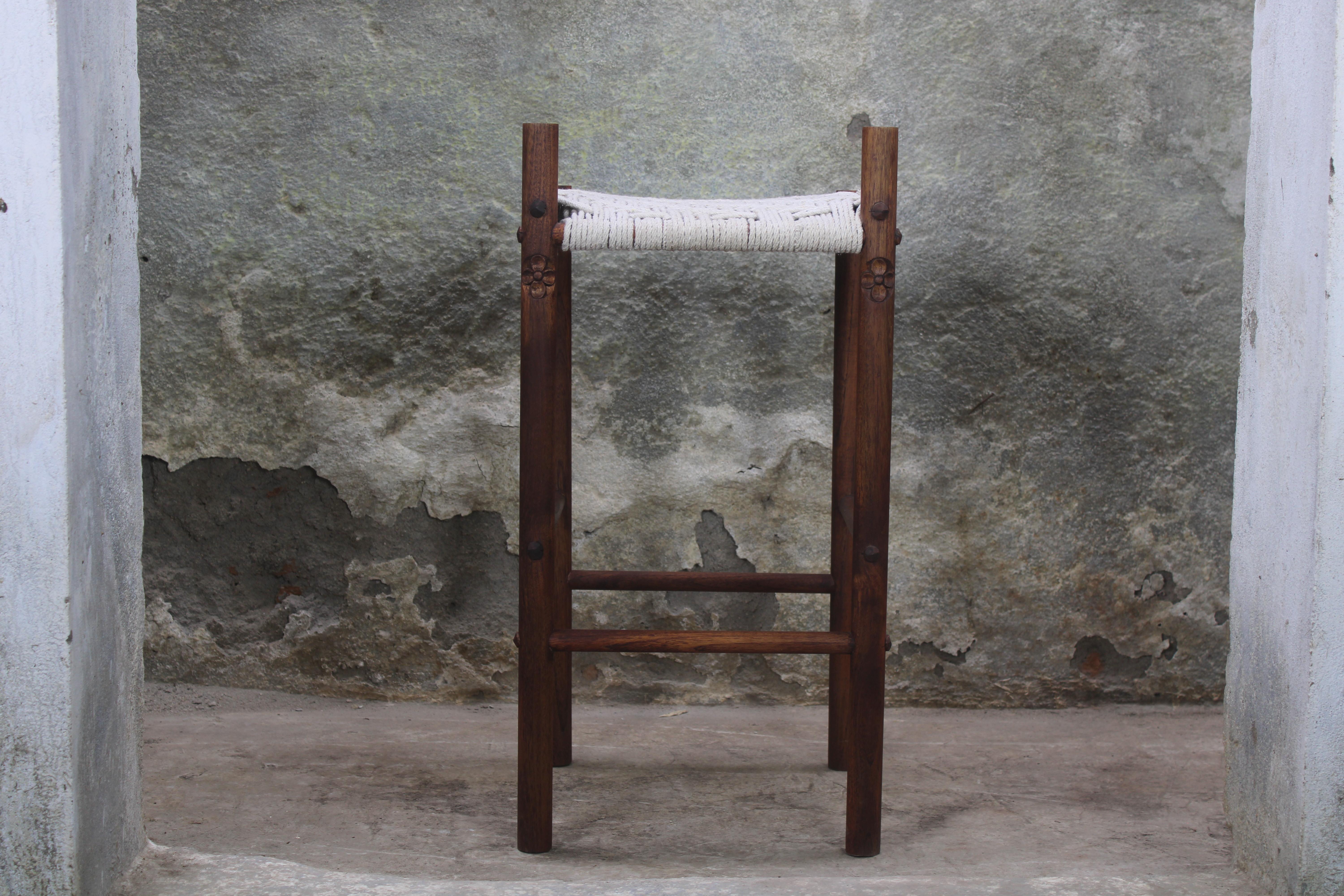 The Iris counter stool is so named after the flowers hand carved into its back legs.  The seat of the stool is hand woven in cotton.  Available in Mango or Teak, the height of the stool is also customizable. 

In a secluded garden, nestled among a