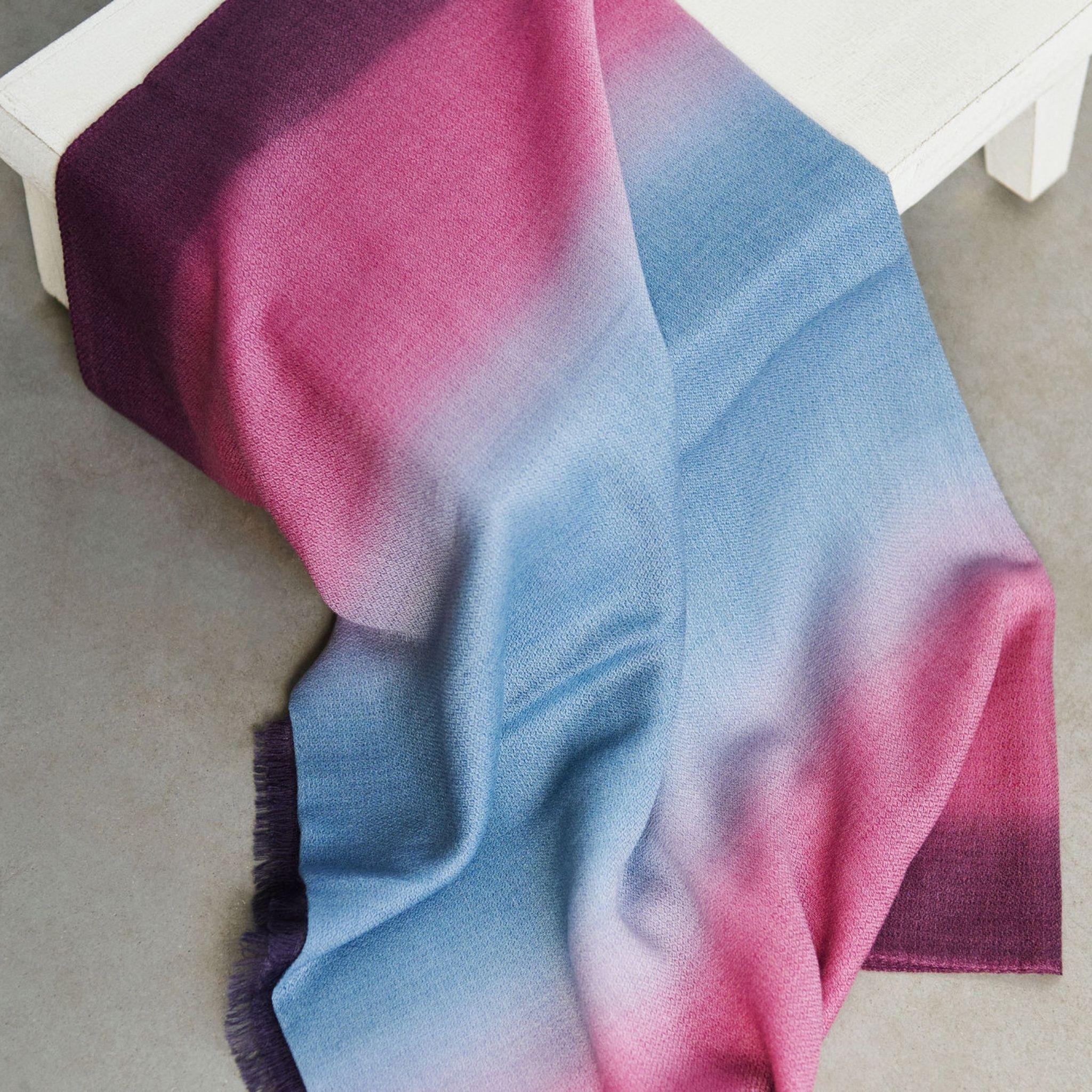 Combining simplicity & elegance with artistic luxury, Iris Haze Scarf has been carefully dyed by master artisans to give this beautiful one of a kind effect of colors blending. The fine micro diamond weave texture of merino & cashmere add value to