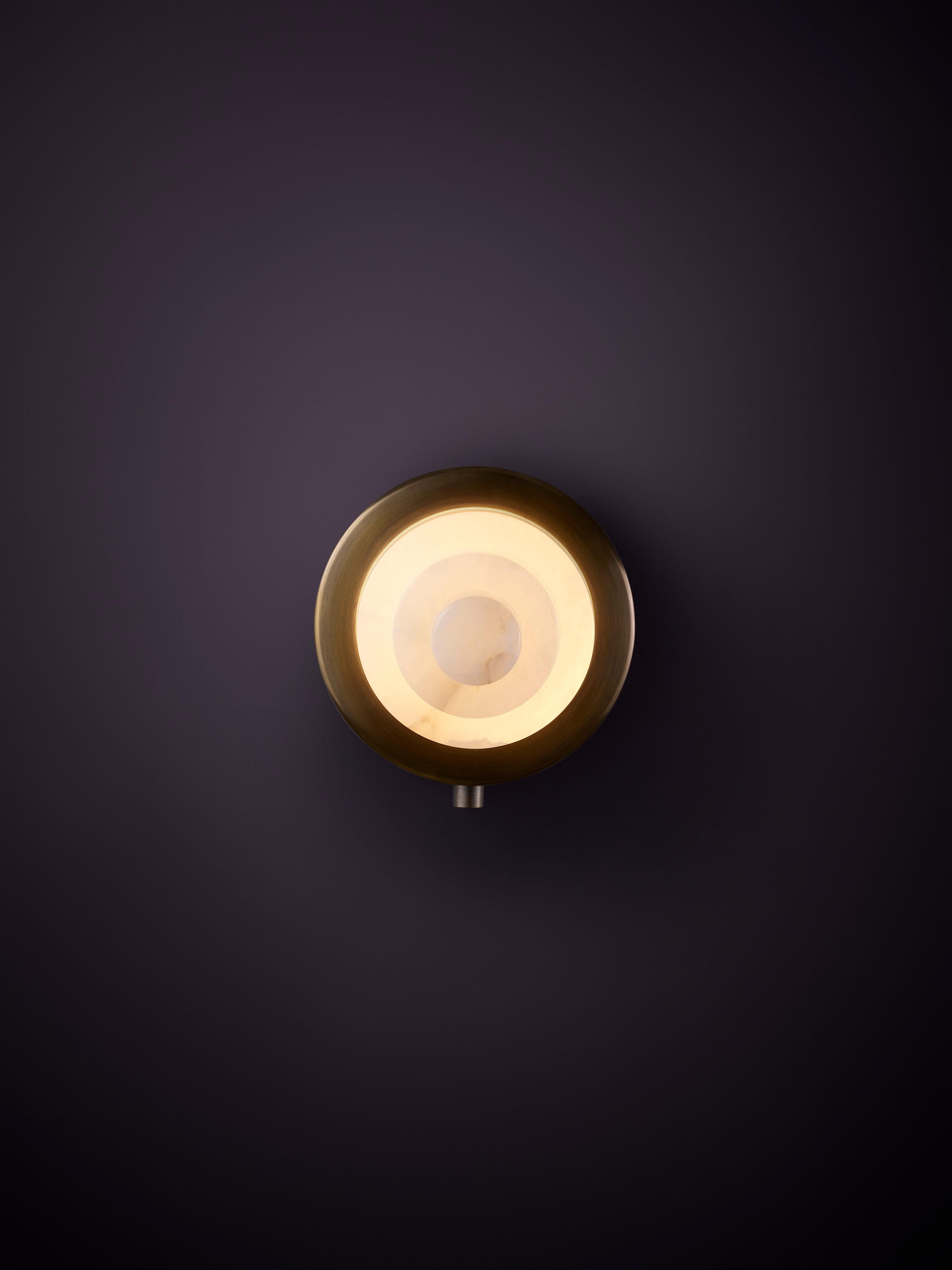 Iris Mono Sconce by Christopher Boots
Dimensions: D 12.5 x H 7.5 cm.
Materials: Brass, alabaster.

Available in Aged Brass, Brushed Brass, Hand Rubbed Brass, or Dark Bronze Please contact us.

The IRIS collection encompasses a series of pendants and