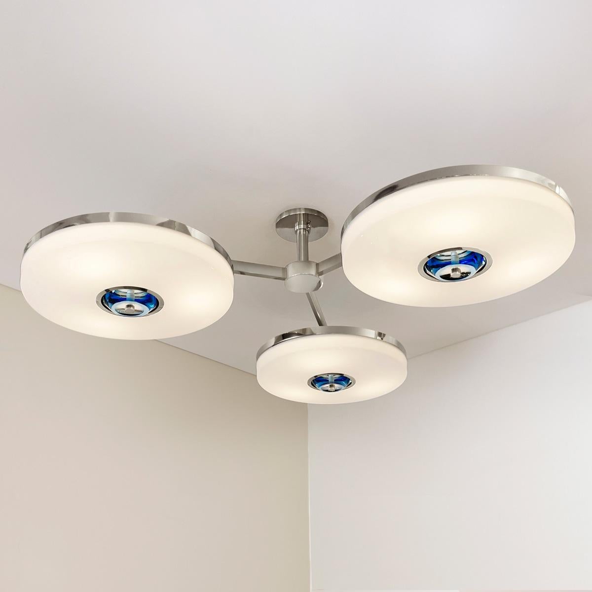 The Iris N.3 ceiling light is designed around three expansive acrylic shades with hand carved glass centers. This versatile fixture can be installed on a stem or as a flush mount. The first images show the fixture in our polished nickel
