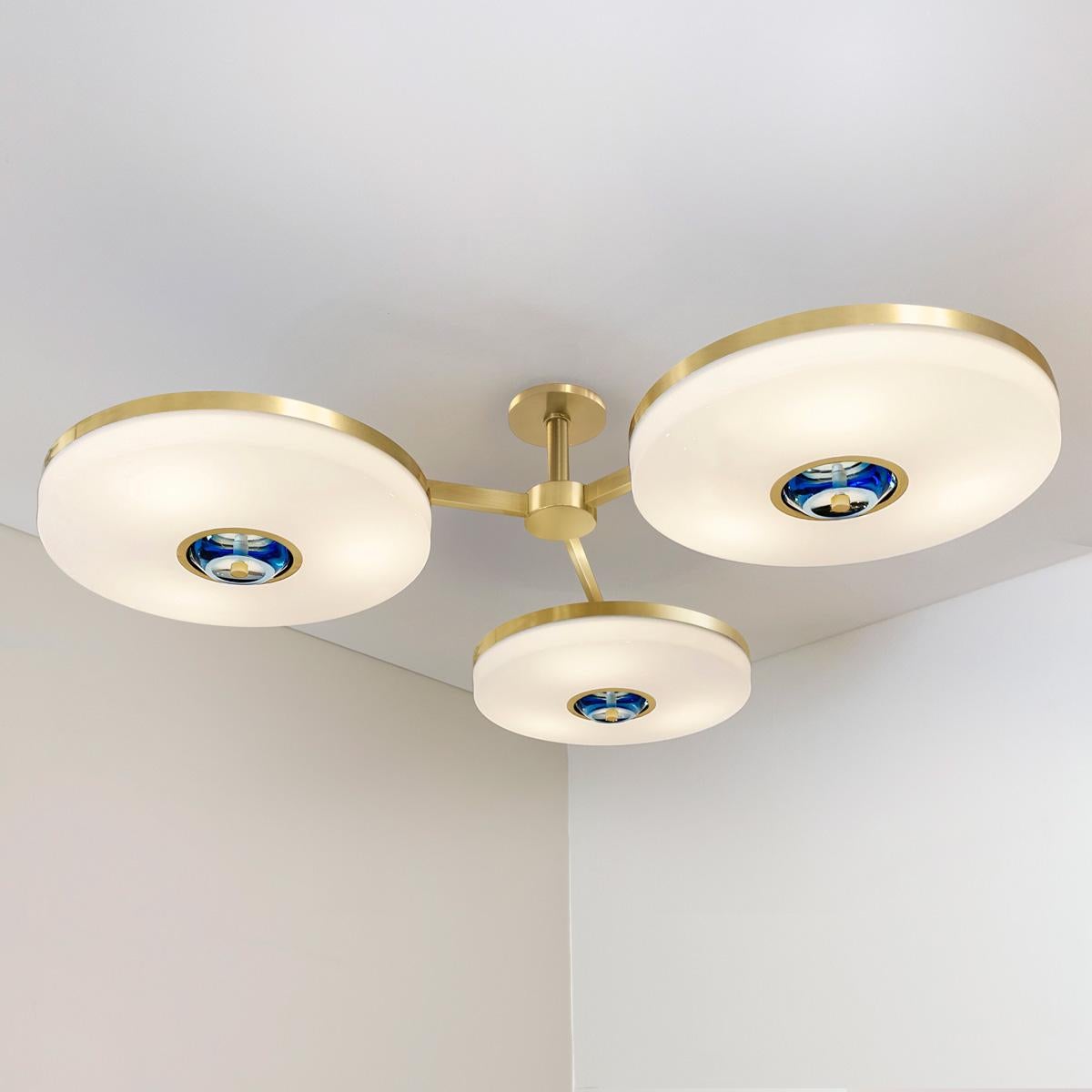 The Iris N.3 ceiling light is designed around three expansive acrylic shades with hand carved glass centers. This versatile fixture can be installed on a stem or as a flush mount. The first images show the fixture in our satin brass