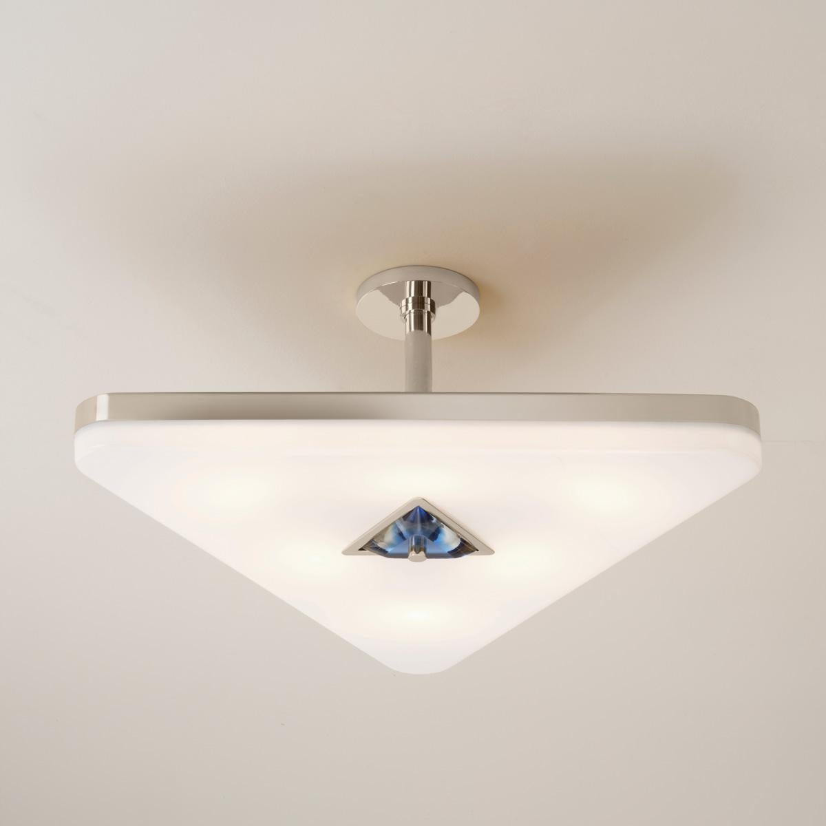 The Iris Triangle ceiling light is designed around an expansive acrylic shade with a hand carved glass center reminiscent of a gemstone. This versatile fixture can be installed as a pendant on a stem or as a flush mount. Can be used with the Iris
