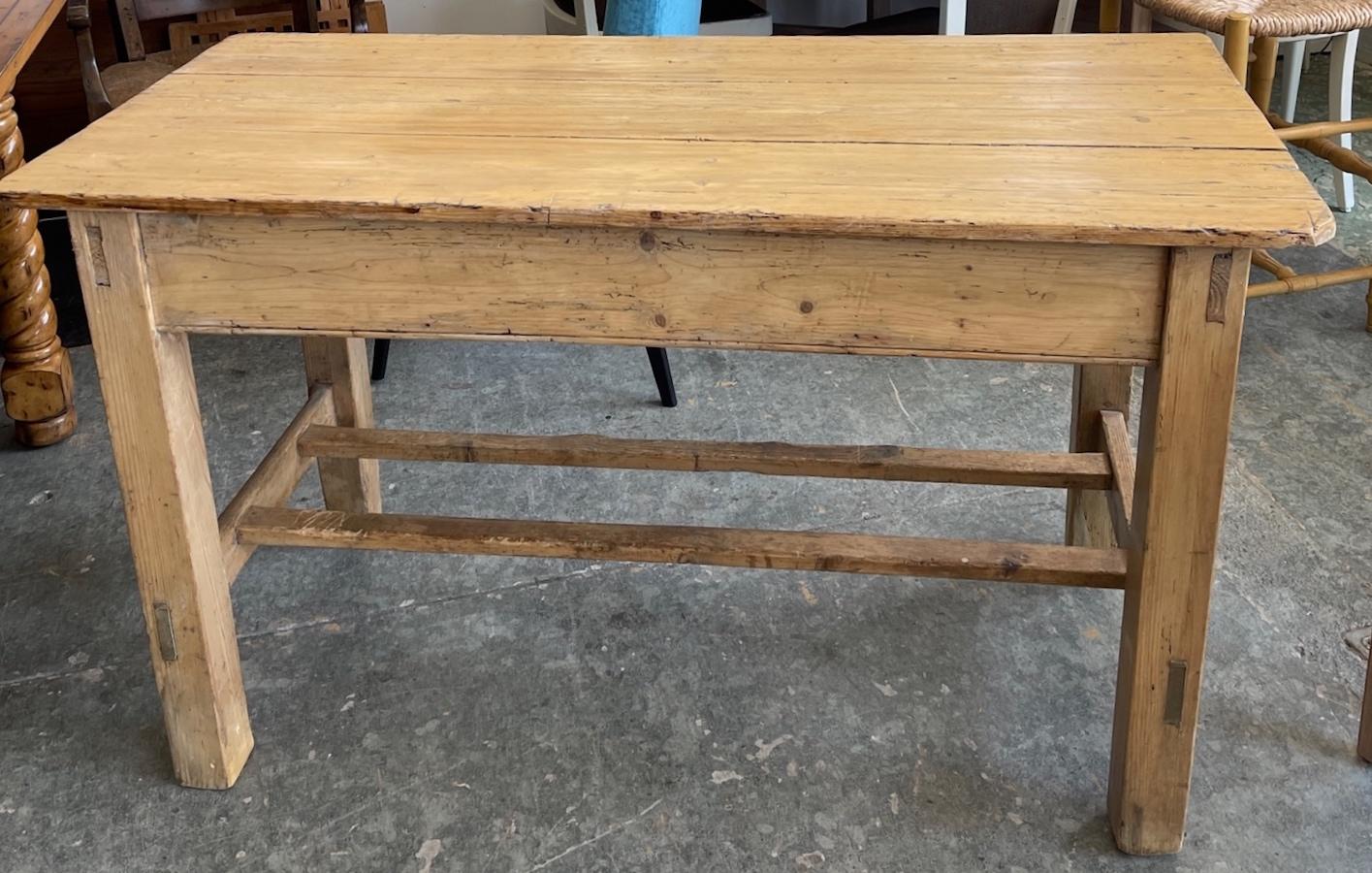 This is a good example of an 19th century Irish breakfast or small dining table. It is made of pine which was most popular for these types of tables using the method of tongue and groove method of assembly.. It has a center drawer usually used for