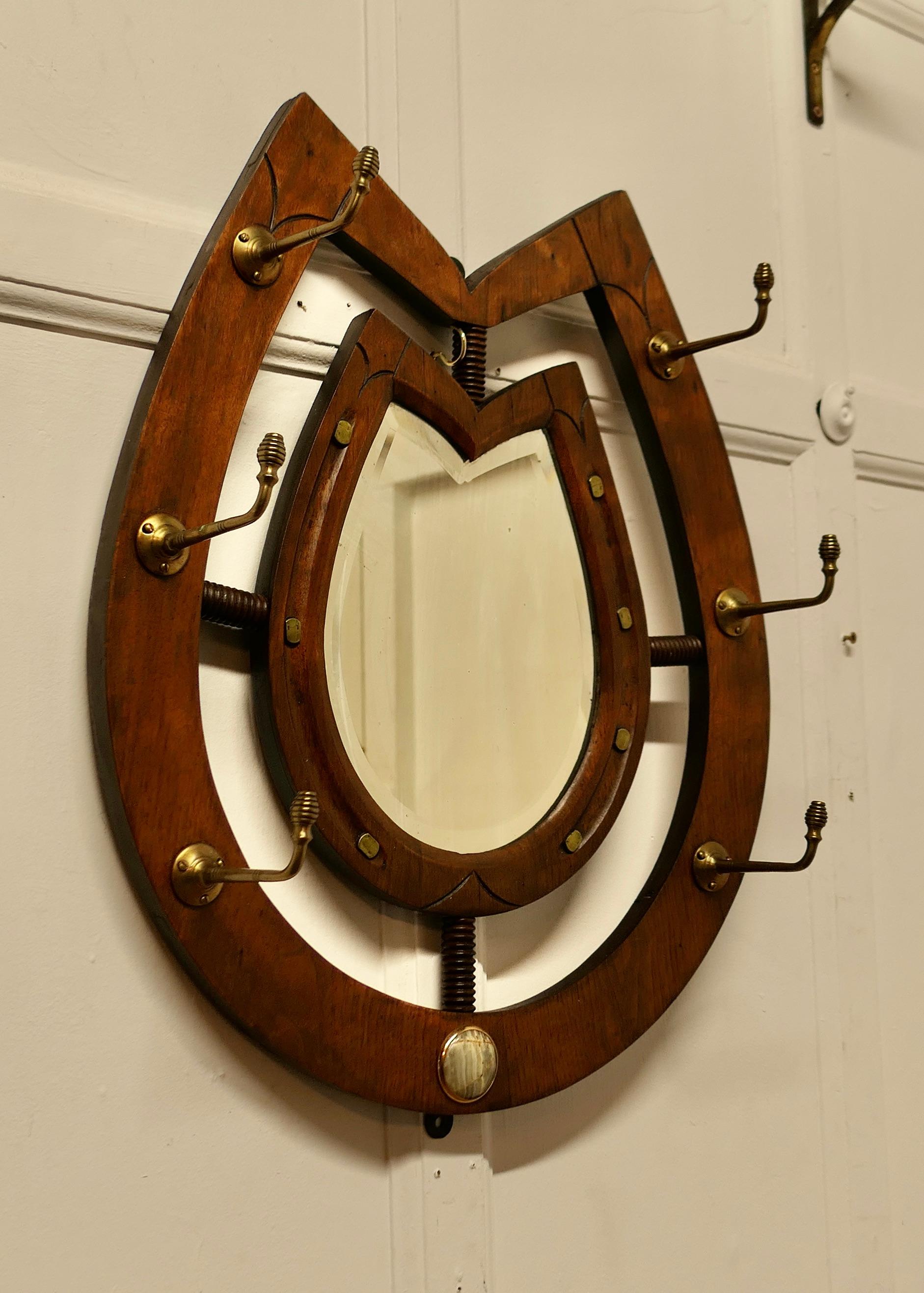 Irish Arts and Crafts Mirrored Horseshoe Coat and Tack Rack 

A fine quality piece and a very attractive design, a double carved Horseshoe Coat and Tack Rack with a bevelled mirror to the centre

Beautifully made with brass farriers nails around the