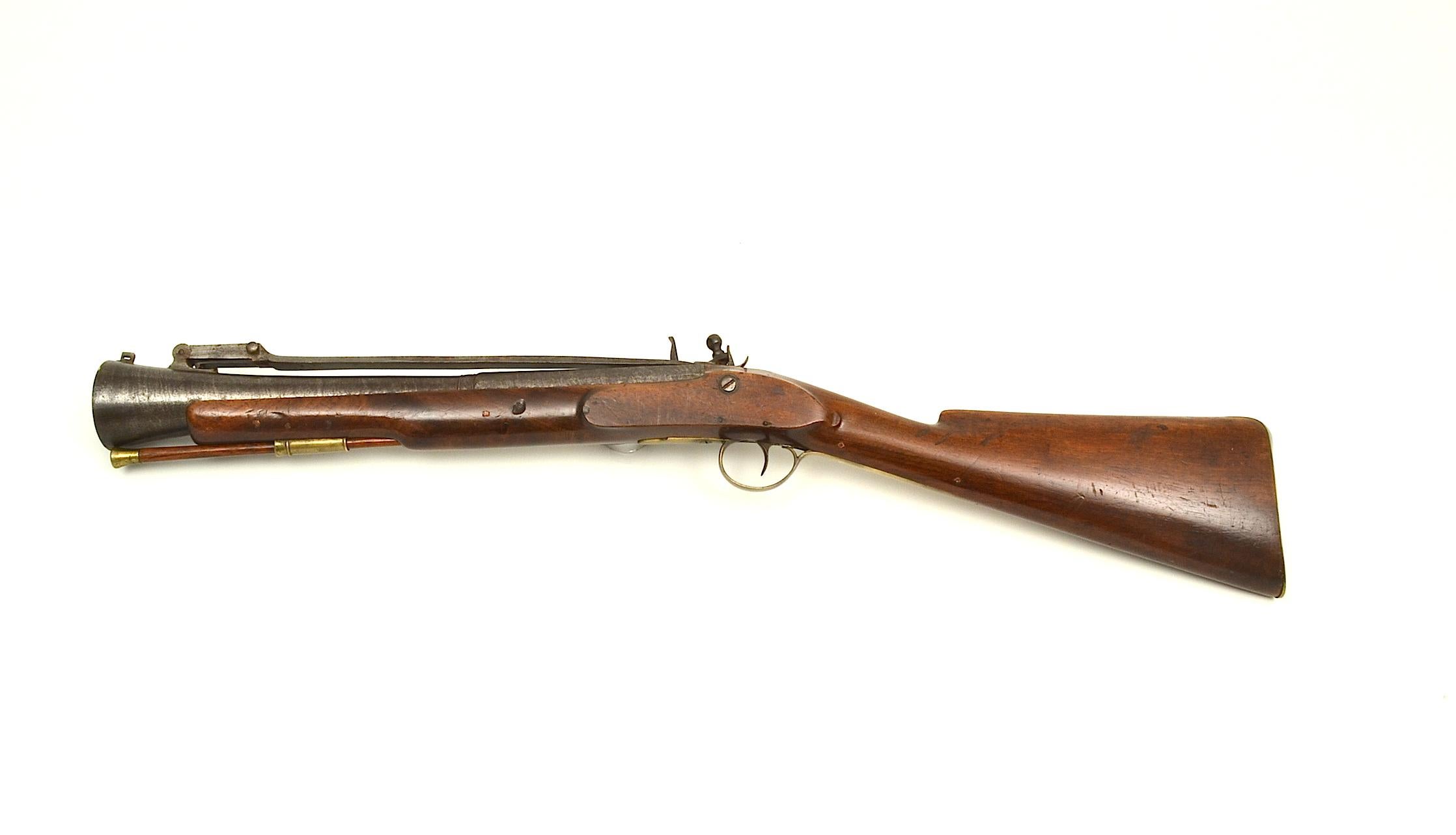 An attractive Irish steel barrelled flintlock blunderbuss with top spring bayonet by Trulock, Dublin, heavy swamped twist barrel with octagonal breech stamped “Trulock” and with Dublin registration number, the 14” spring bayonet released by thumb