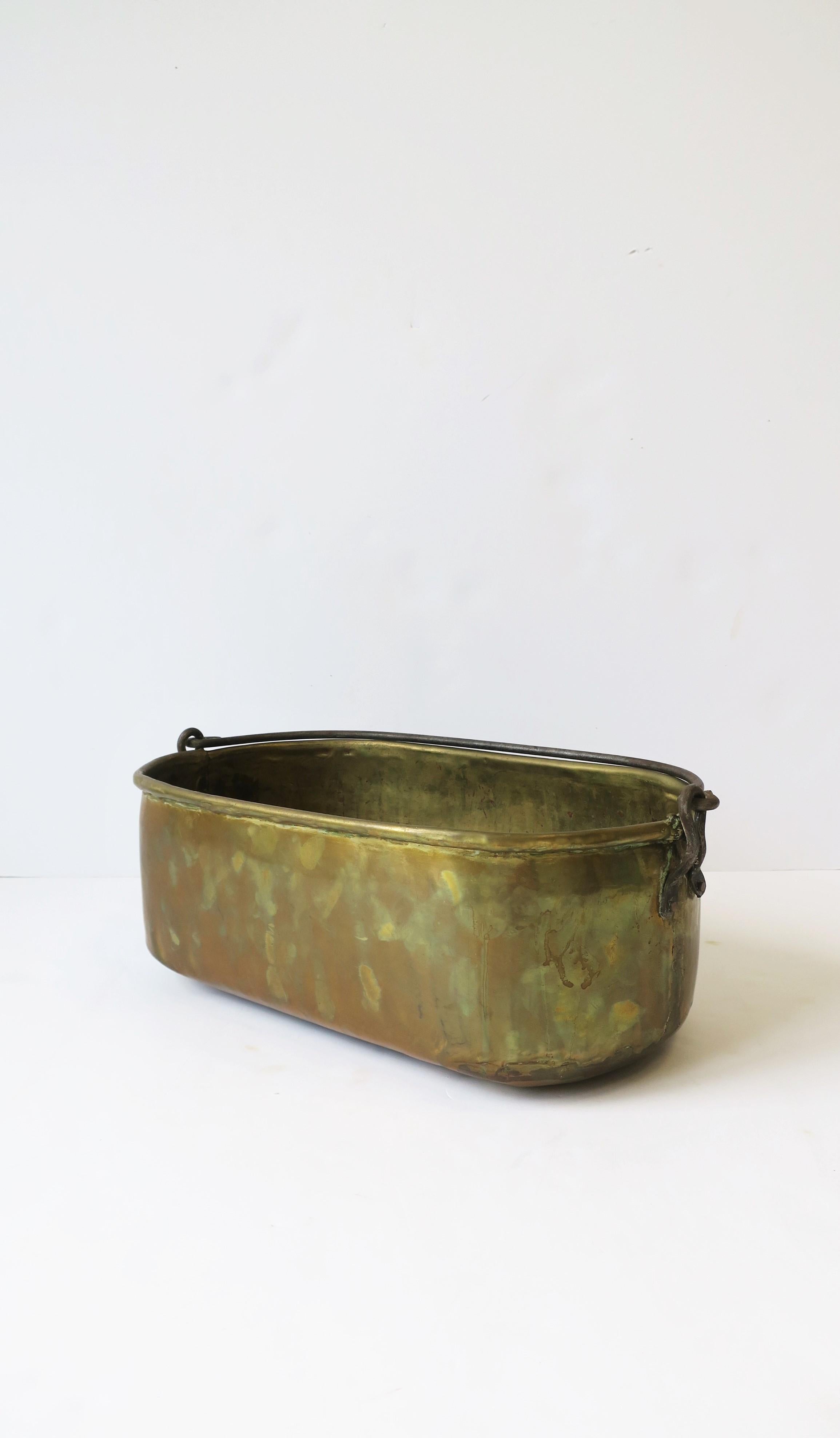 A beautiful Irish brass bucket with handle, circa 20th century, Republic of Ireland. Brass bucket is oblong with copper nails. A great decorative piece or for a bar/entertaining area as an ice bucket or cooler for wine, Champagne, beer, etc. Piece