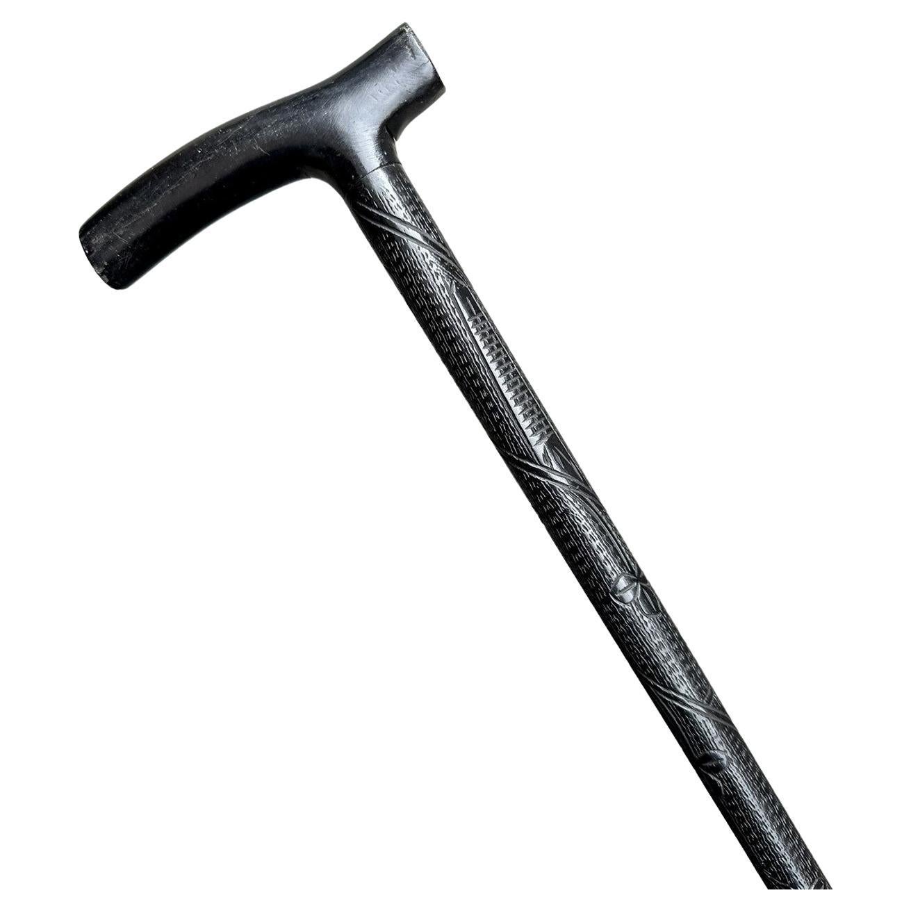 Extremely rare hand carved Irish Bog Oak Walking Stick, of outstanding quality, made in Ireland during the last half of the Nineteenth Century. 

The ornately carved horizontal tau shaped grip above a finely carved shaft depicting an Irish Harp