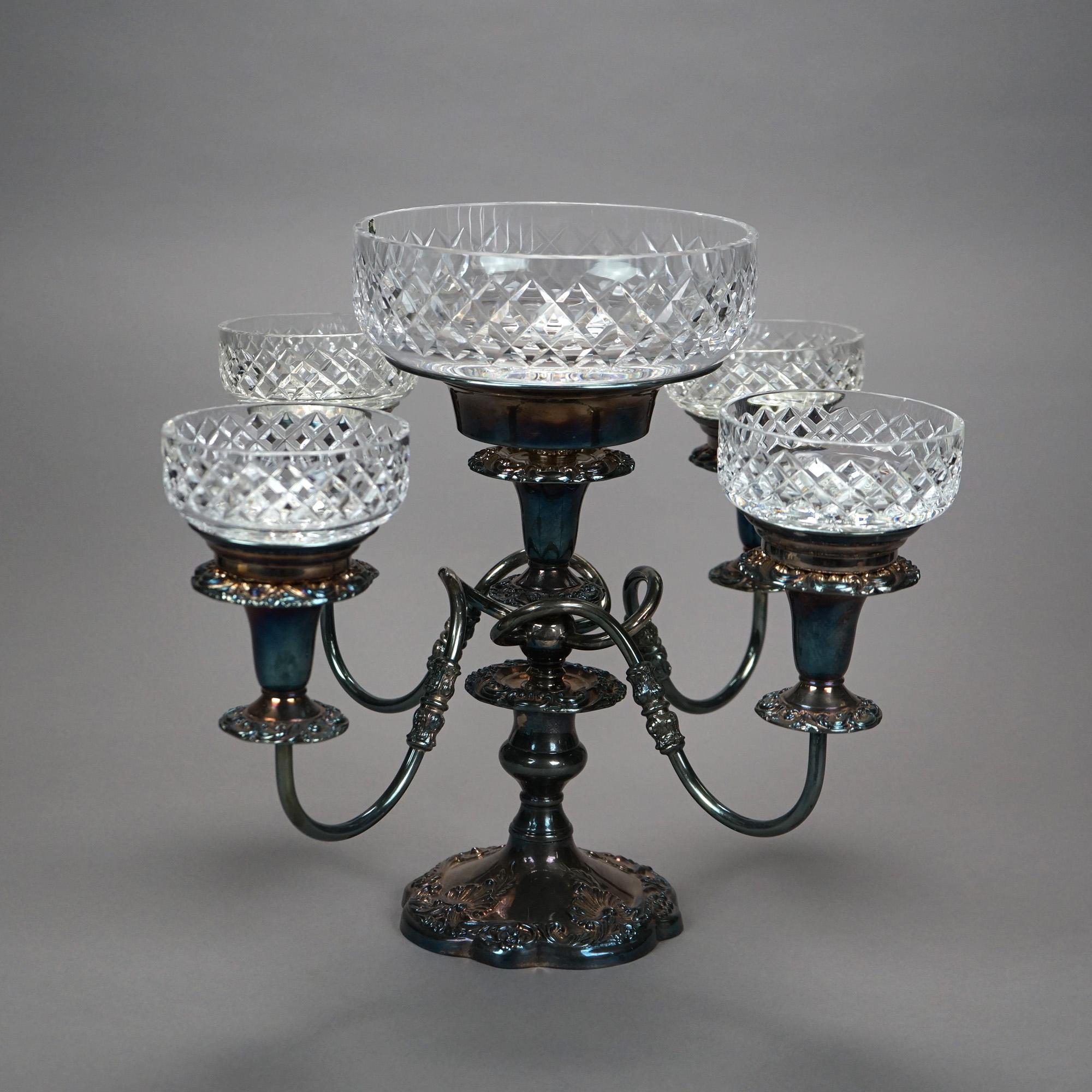 A, Irish Innisfree Cavan epergne offers cut lead crystal bowls on Sheffield silver plate base having four scroll form arms, maker label and stamp as photographed, 20th century

Measures- 14.25''H x 14.5''W x 14.5''D

