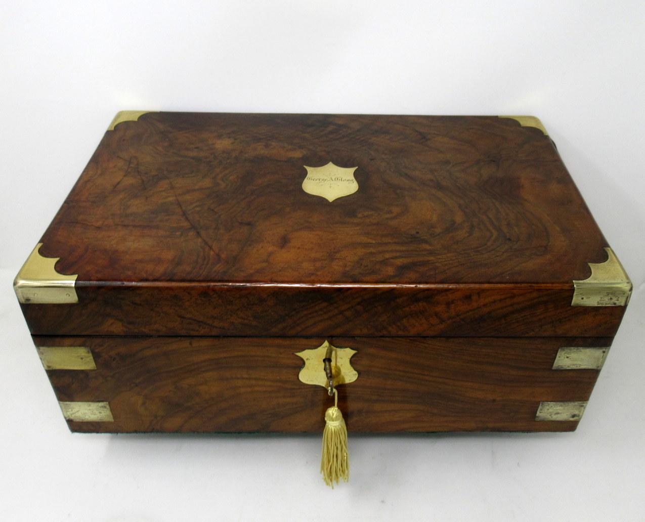 An exceptionally fine quality Irish well figured solid burr walnut ladies or gents travelling writing slope of outstanding quality and large proportions, with unusual moulded brass inlay decoration and central shield shaped brass tablet on hinged
